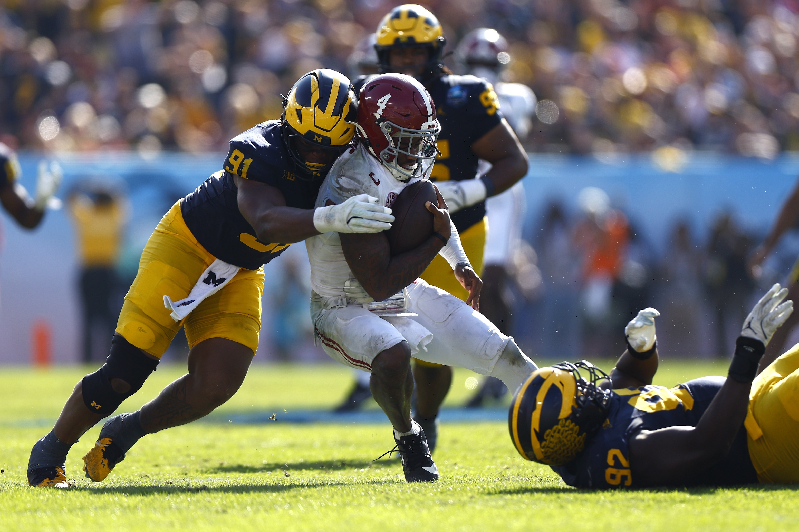 Jalen Milroe #4 of the Alabama Crimson Tide is sacked by Cameron Brandt #91 of the Michigan Wolverines during the third quarter in the 2024 ReliaQuest Bowl at Raymond James Stadium on December 31, 2024.