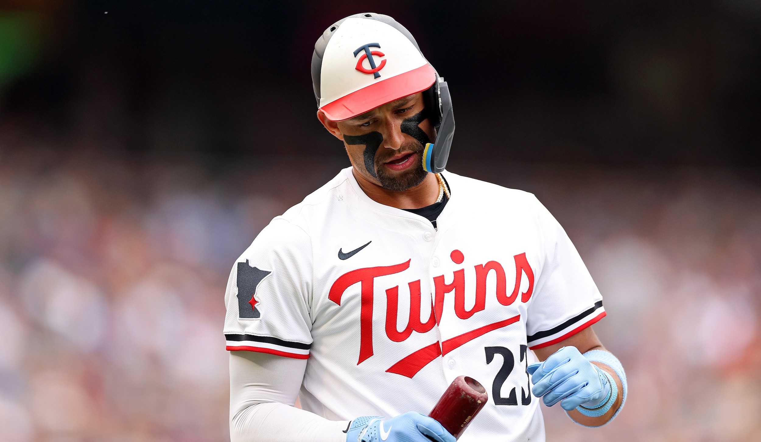 Royce Lewis looks at his bat.