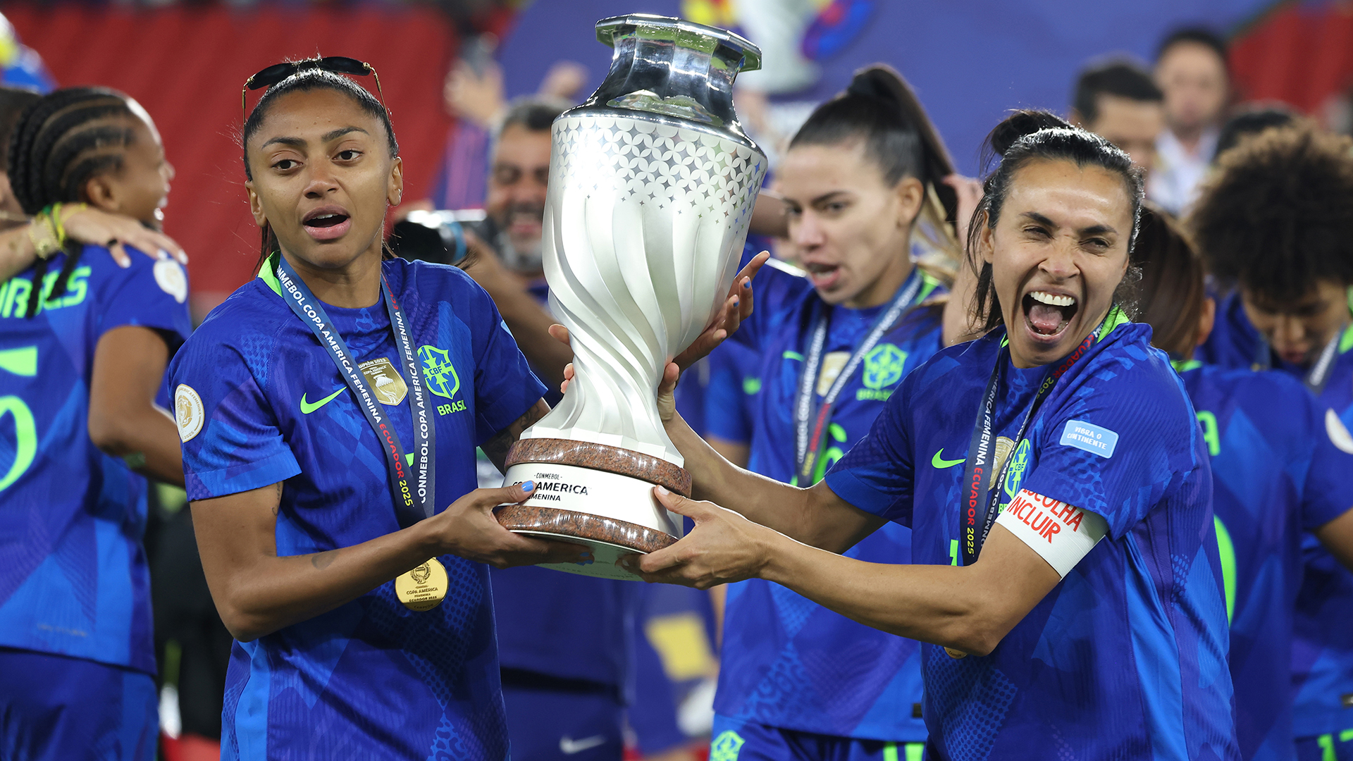 Marta Vieira and Kerolin Israel of Brazil hold the trophy after the CONMEBOL Copa America Femenina 2025 Final match between Colombia and Brazil at Rodrigo Paz Delgado Stadium on August 2, 2025 in Quito, Ecuador.