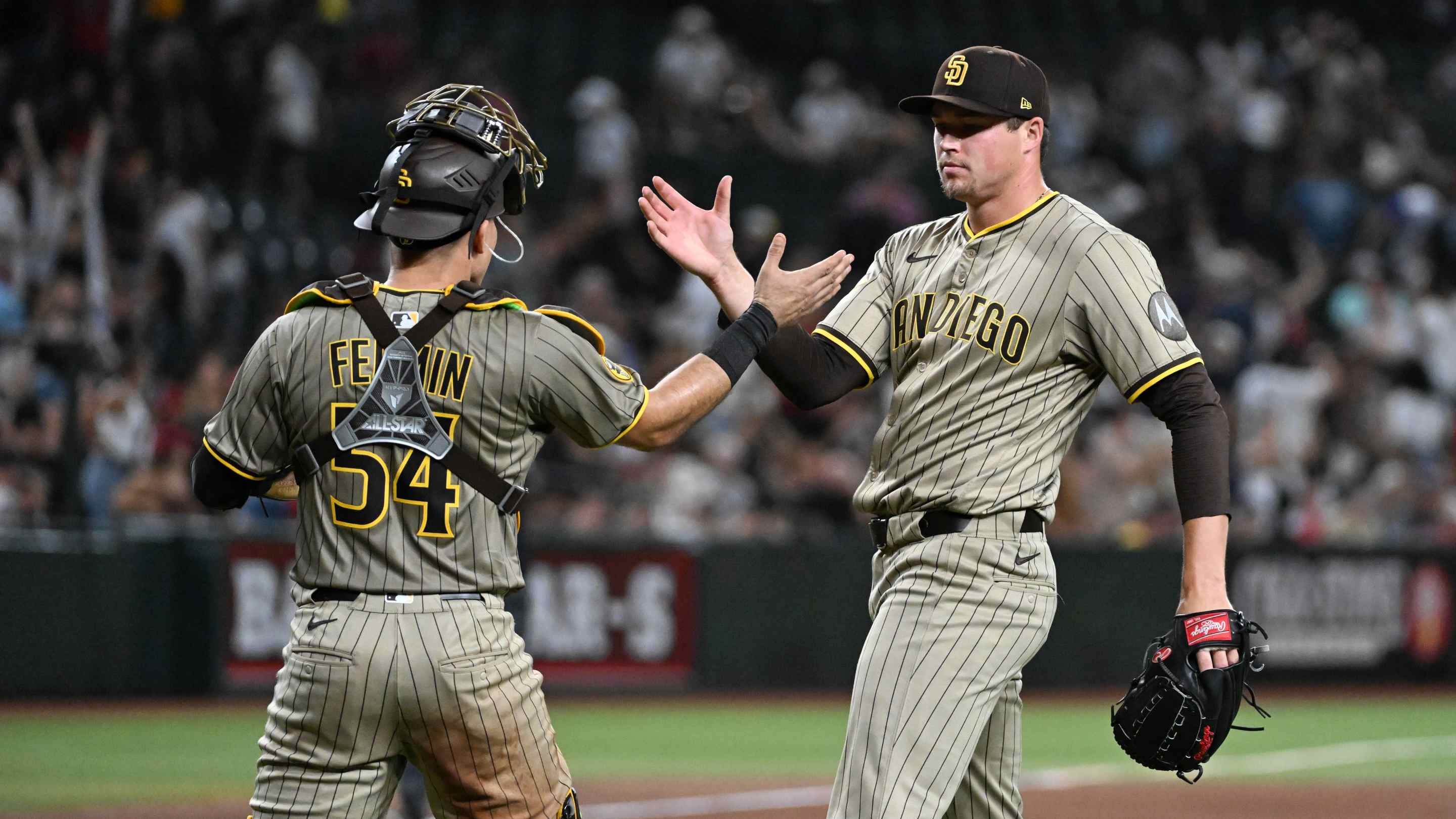 Mason Miller #22 and Freddy Fermin #54 of the San Diego Padres celebrate a 3-2 win against the Arizona Diamondbacks