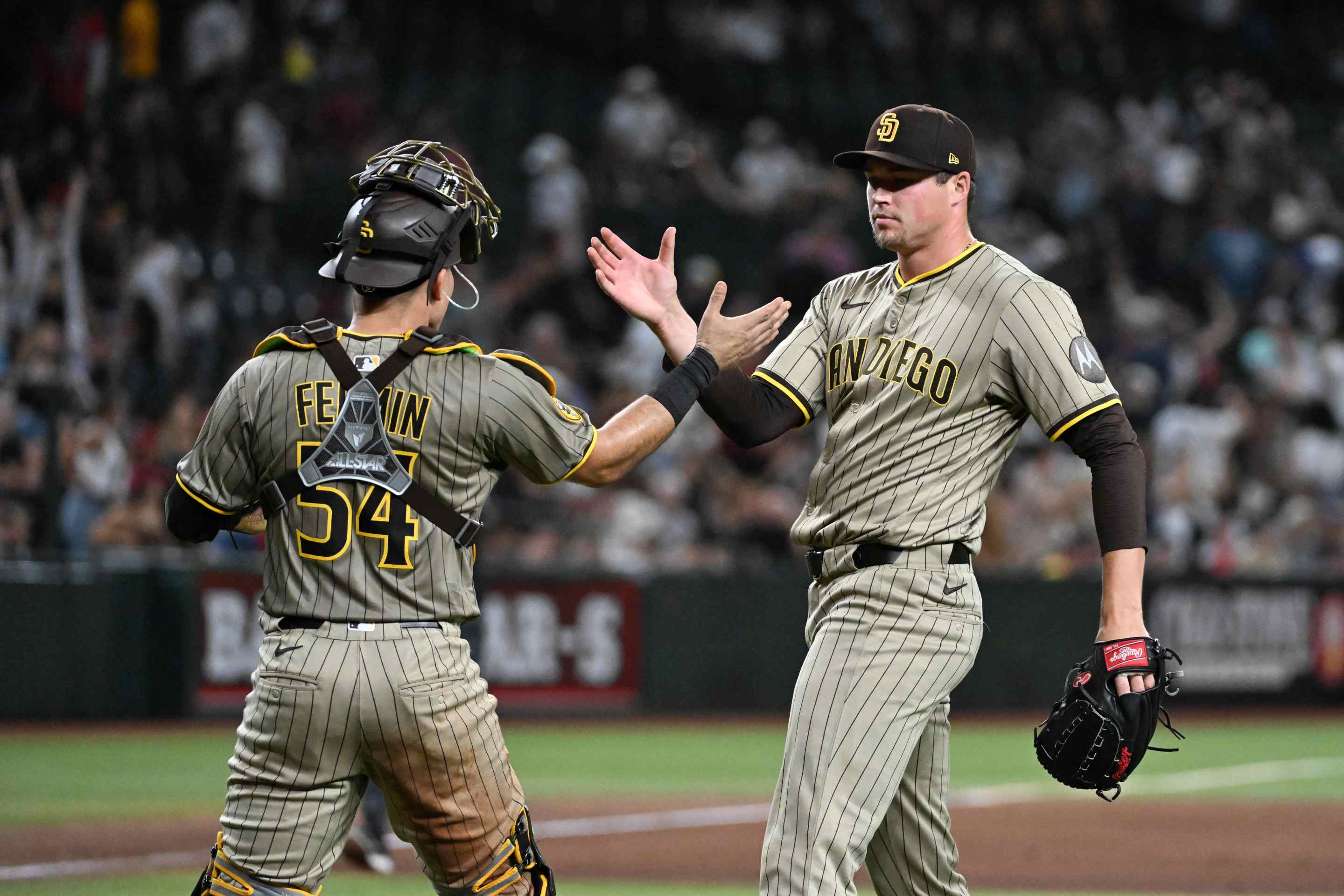Mason Miller #22 and Freddy Fermin #54 of the San Diego Padres celebrate a 3-2 win against the Arizona Diamondbacks