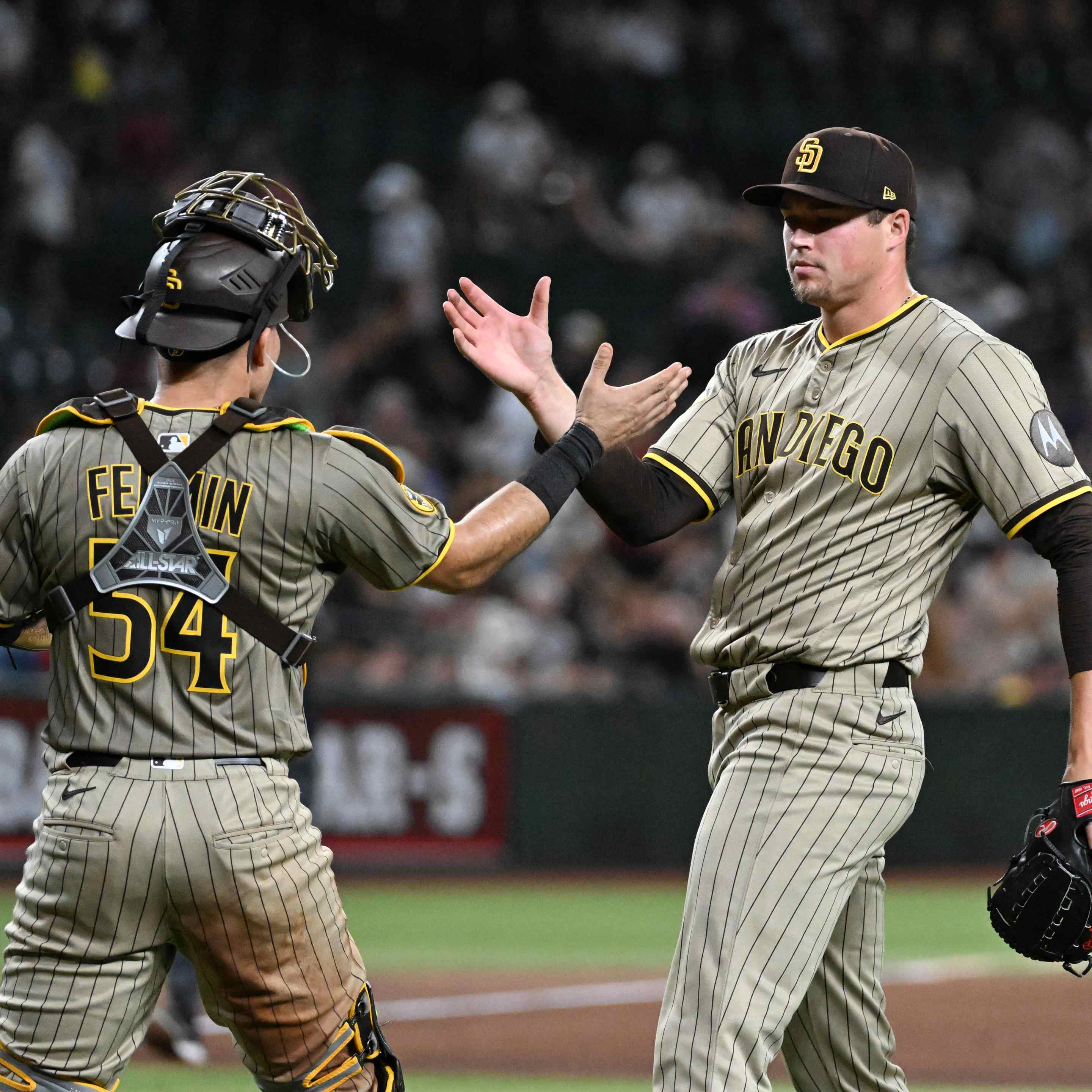 Mason Miller #22 and Freddy Fermin #54 of the San Diego Padres celebrate a 3-2 win against the Arizona Diamondbacks