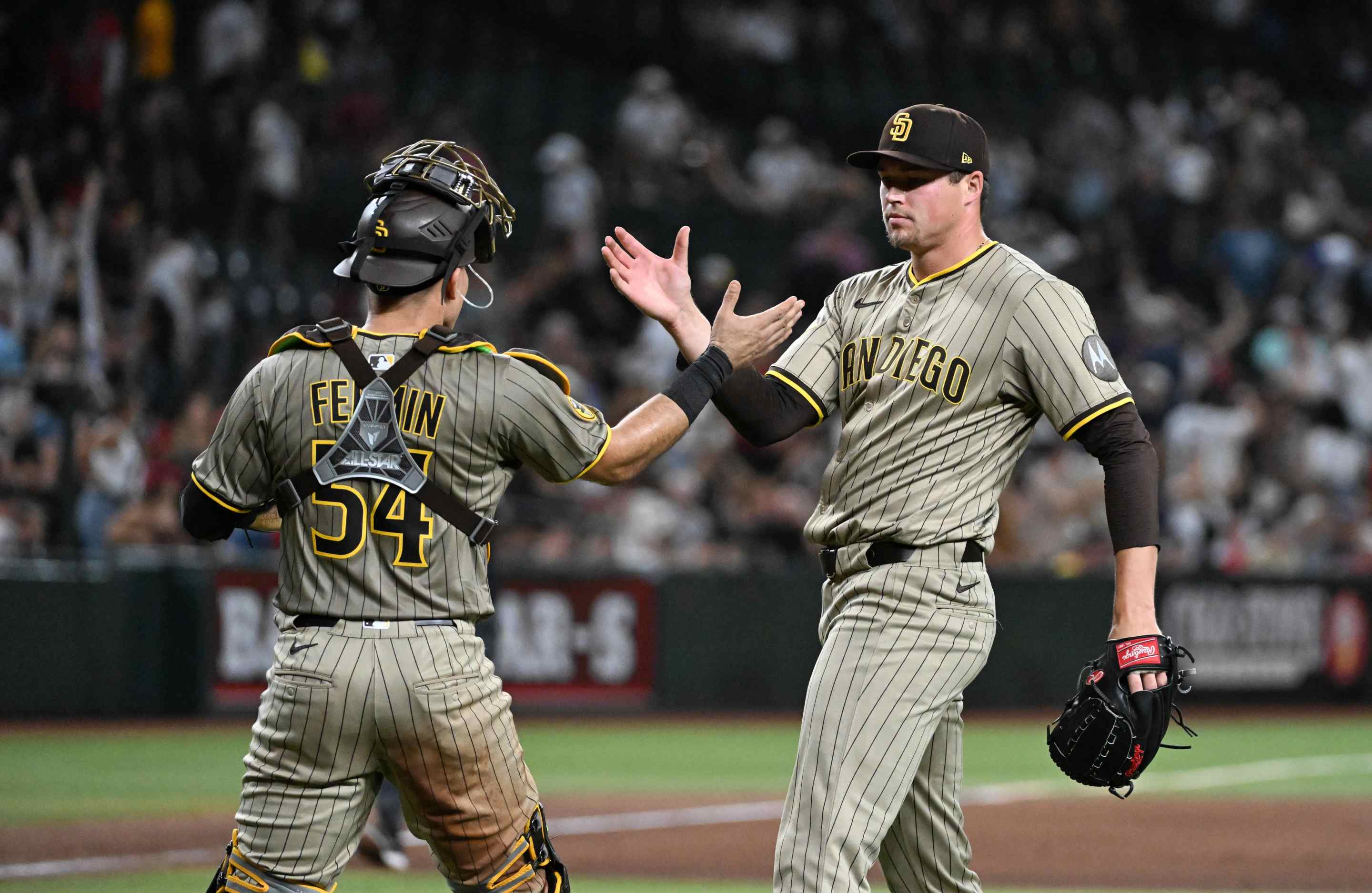 Mason Miller #22 and Freddy Fermin #54 of the San Diego Padres celebrate a 3-2 win against the Arizona Diamondbacks