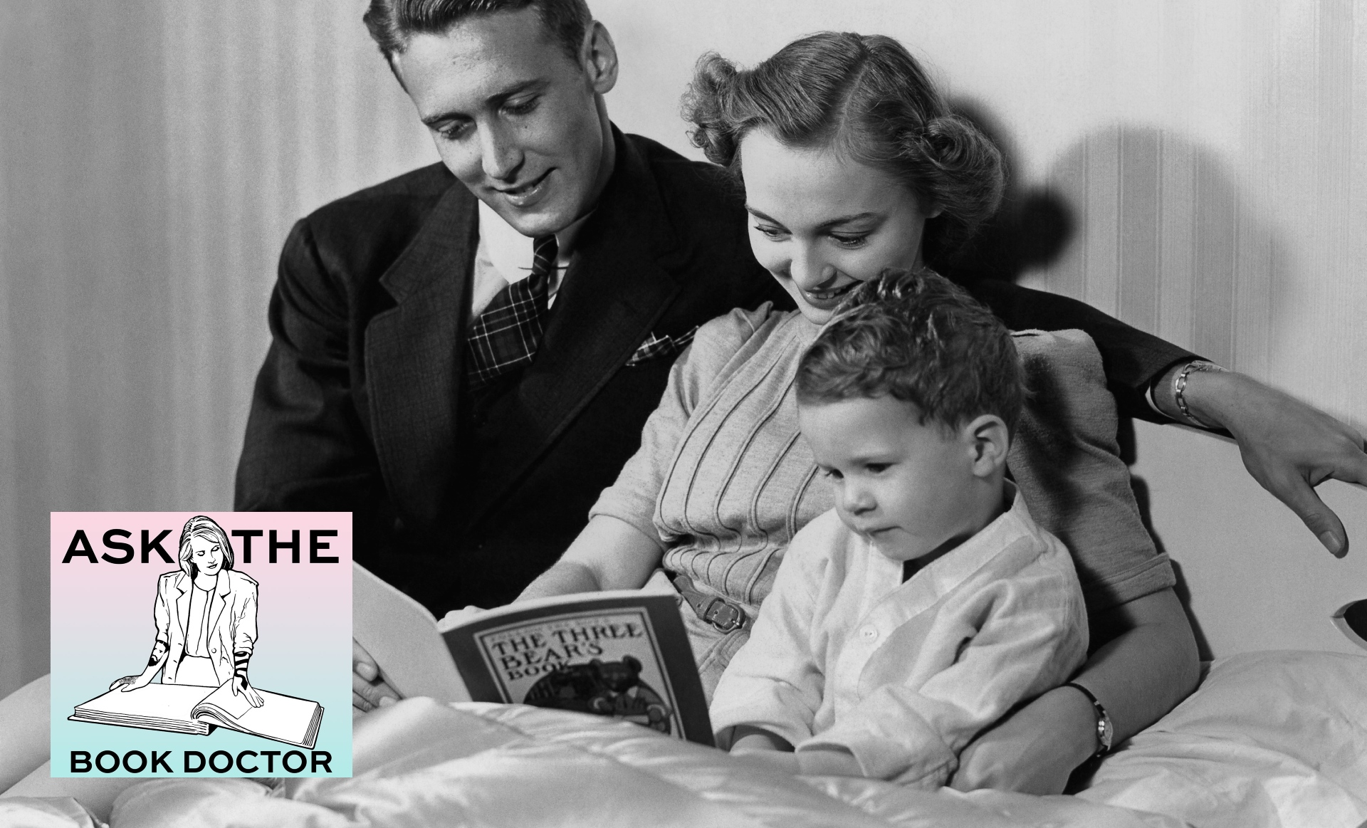 two parents read a book to their child in bed
