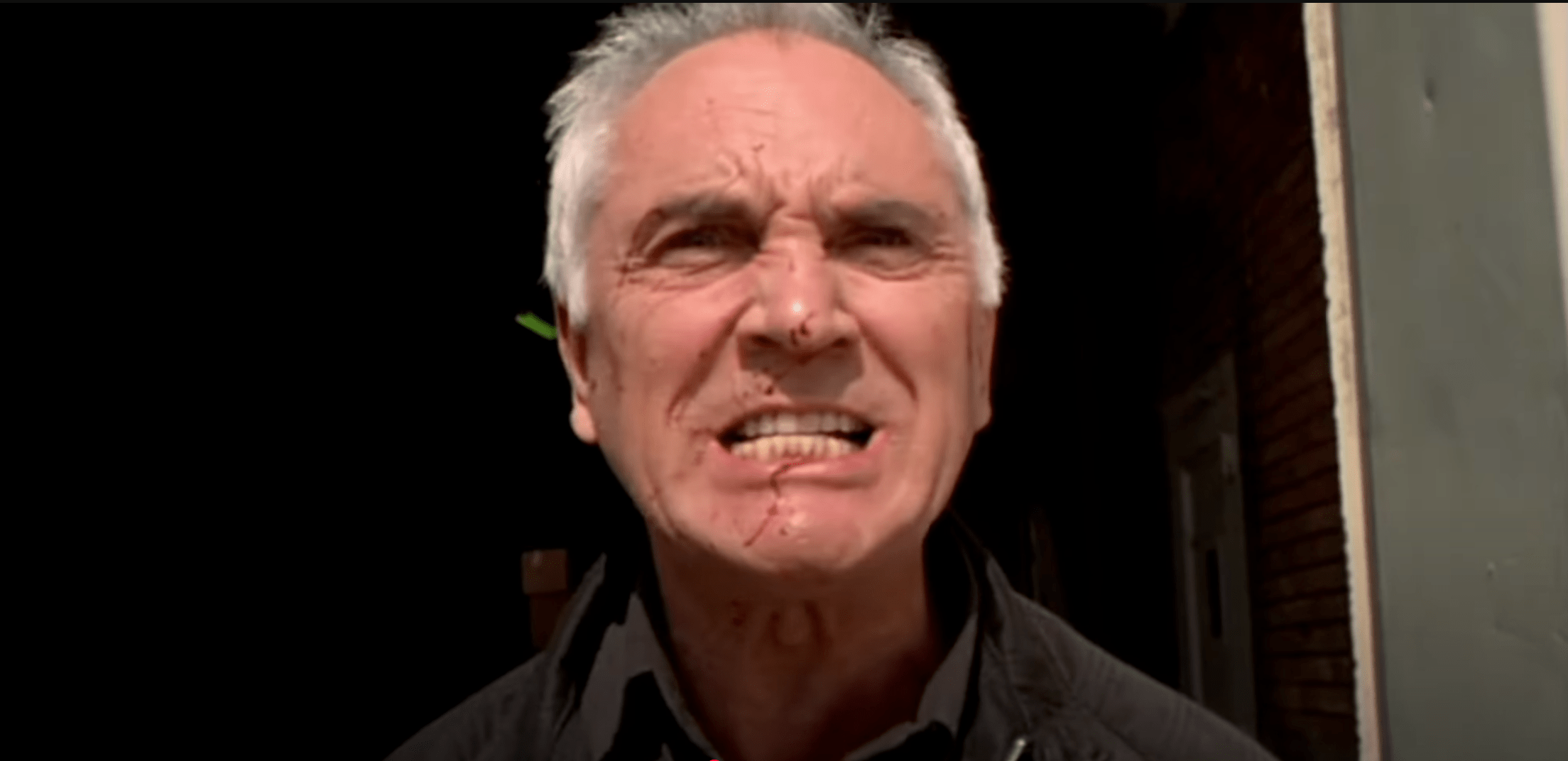 A grimacing Terence Stamp, with some blood splashed across his face, in Stephen Soderbergh's 1999 film "The Limey"