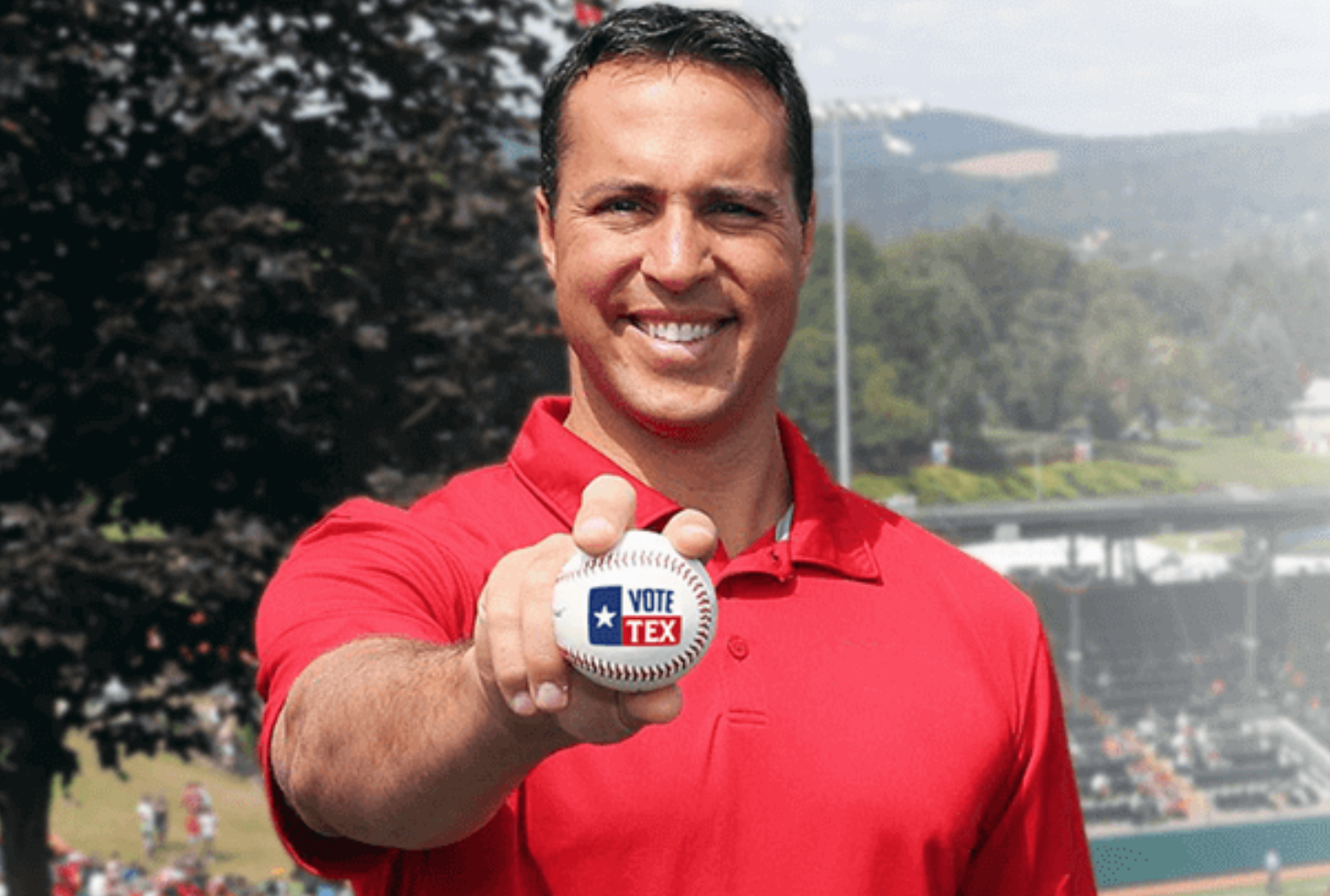 A screengrab from Mark Teixeira's website for his congressional run. He's holding out a baseball and grinning and wearing a tight red golf shirt. It looks like an ad for a real estate agency.