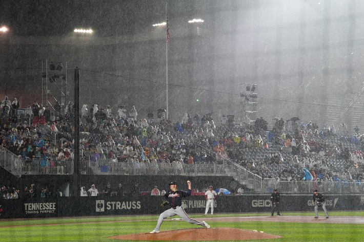 BRISTOL, TENNESSEE - AUGUST 02: Starting pitcher Austin Cox #68 of the Atlanta Braves pitches in the rain during the first inning of the MLB Speedway Classic between the Atlanta Braves and the Cincinnati Reds at Bristol Motor Speedway on August 02, 2025 in Bristol, Tennessee.