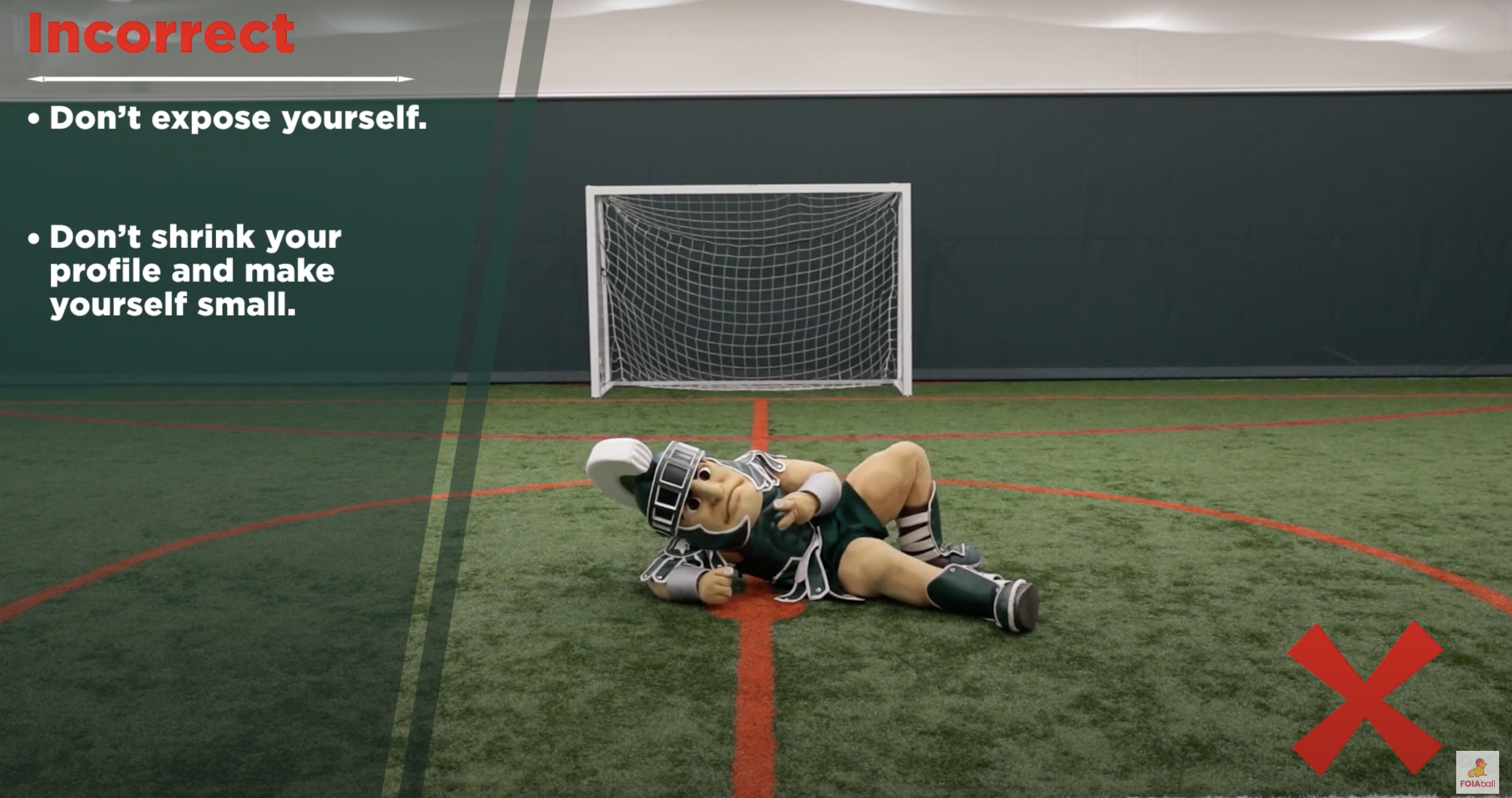 Sparty showing the incorrect way to lay on the field