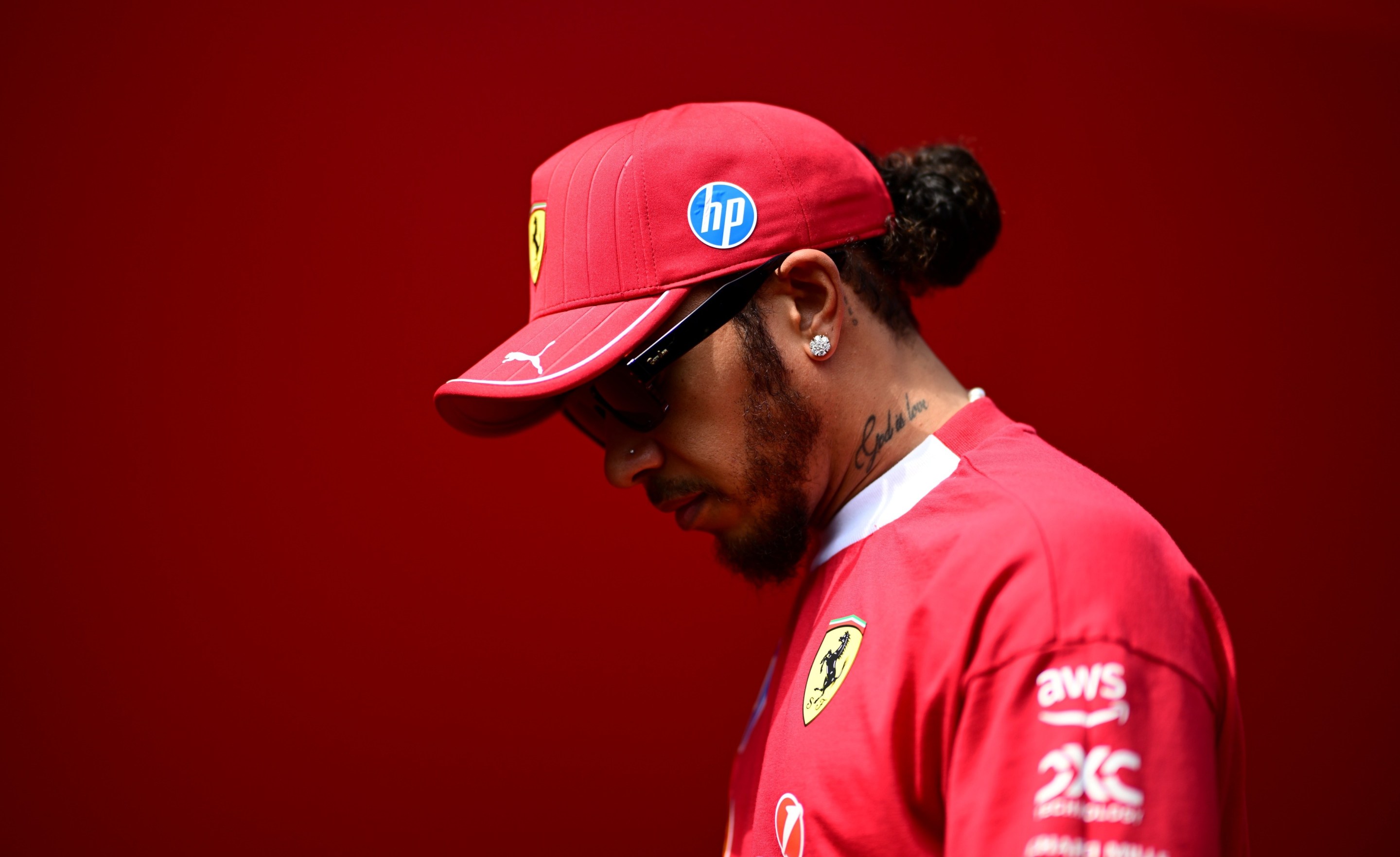 Lewis Hamilton of Scuderia Ferrari walks in the paddock during free practice of the Hungarian GP.