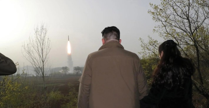 Kim Jong Un and daughter Kim Ju Ae watch a missile launch.
