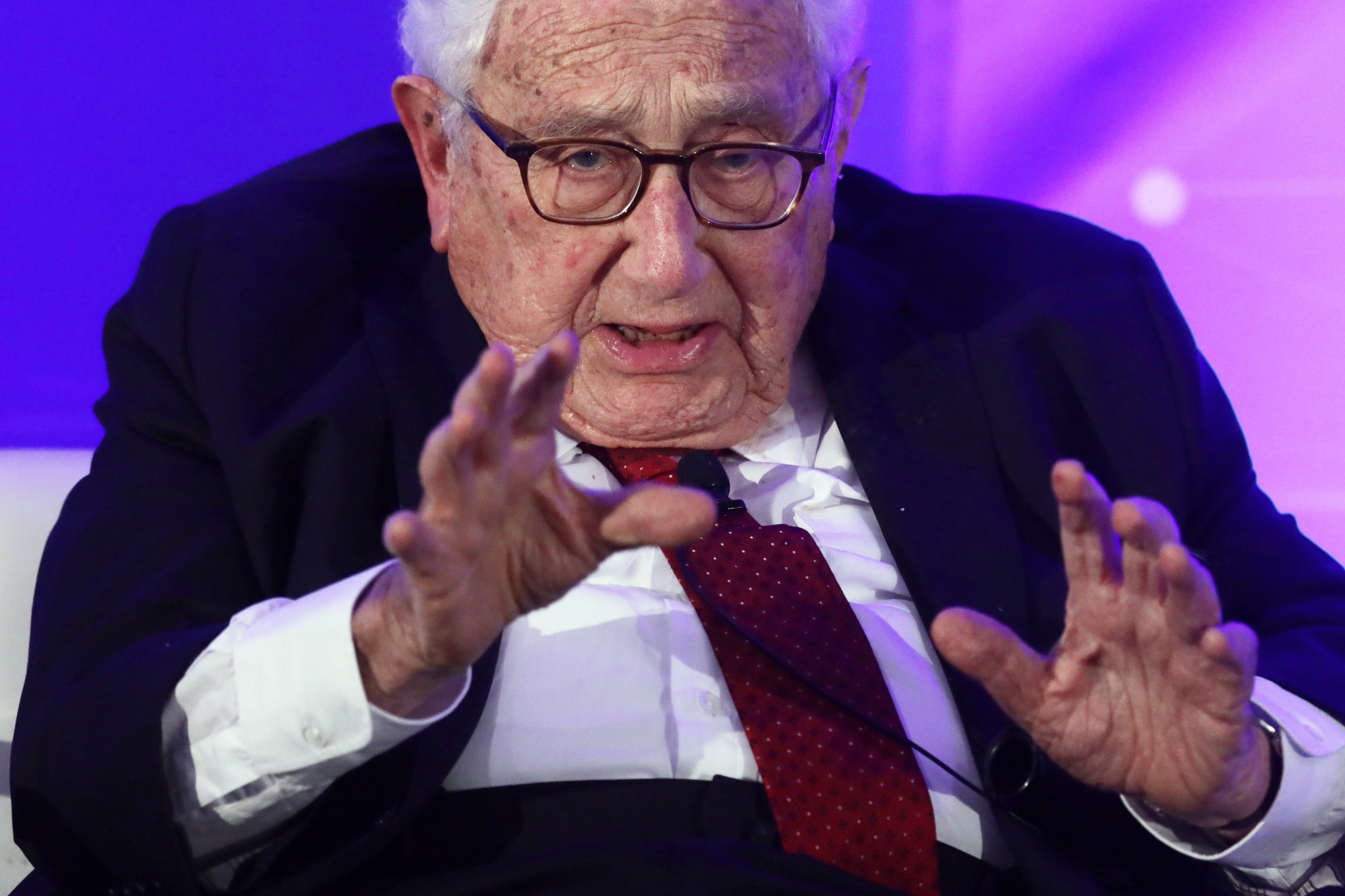 A close up shot of Henry Kissinger looking absolutely decrepit.
