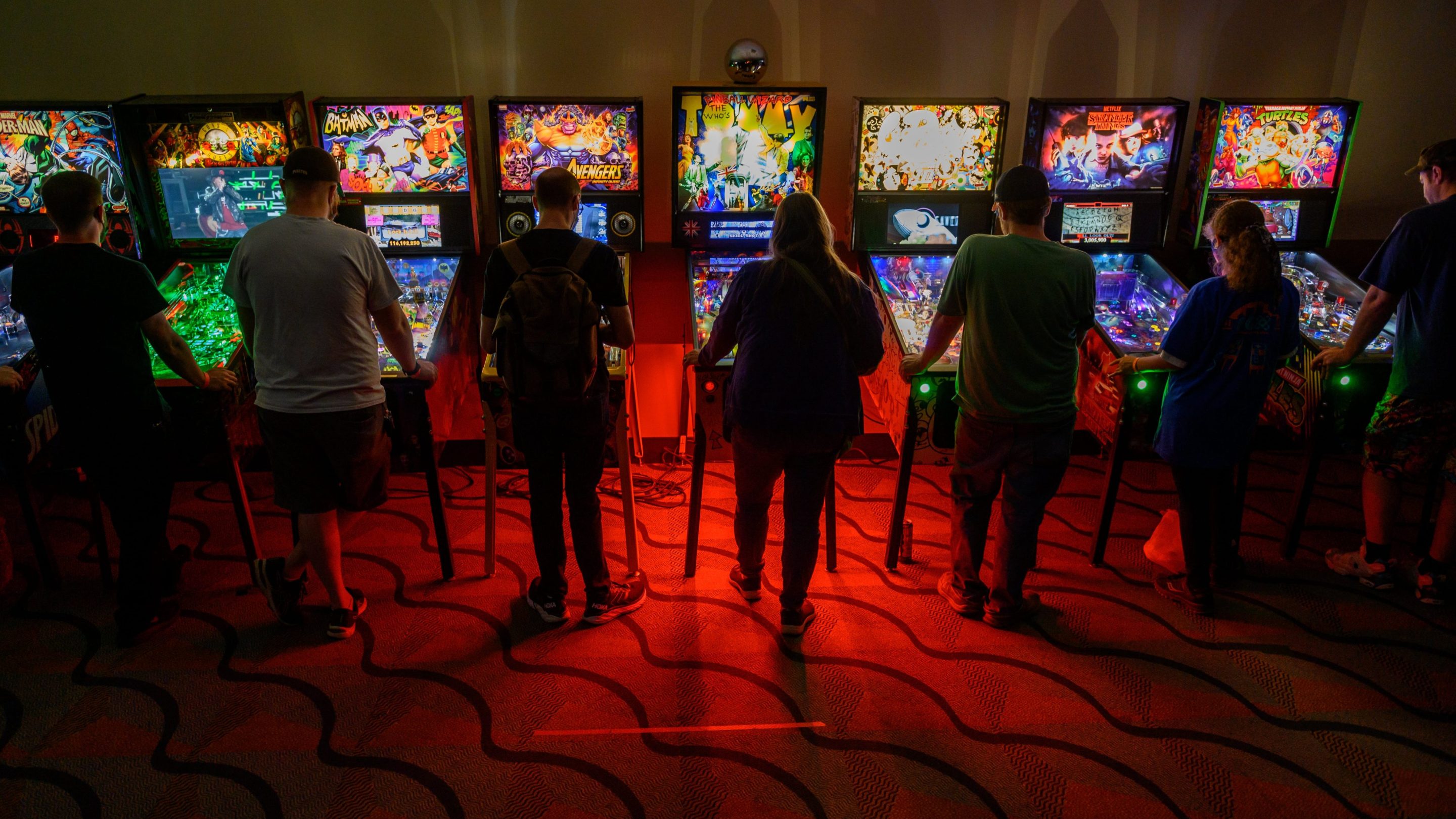 Gamers sample an assortment of pinball machines
