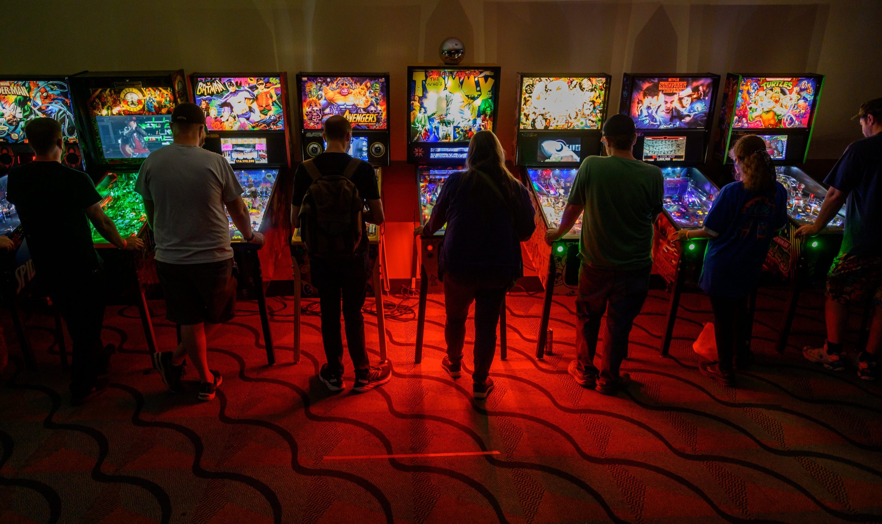 Gamers sample an assortment of pinball machines