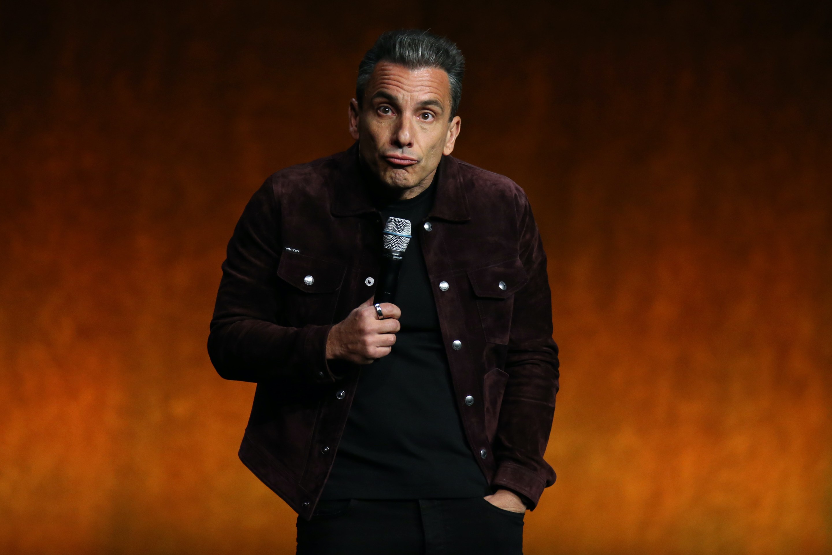 Sebastian Maniscalco performs on stage.
