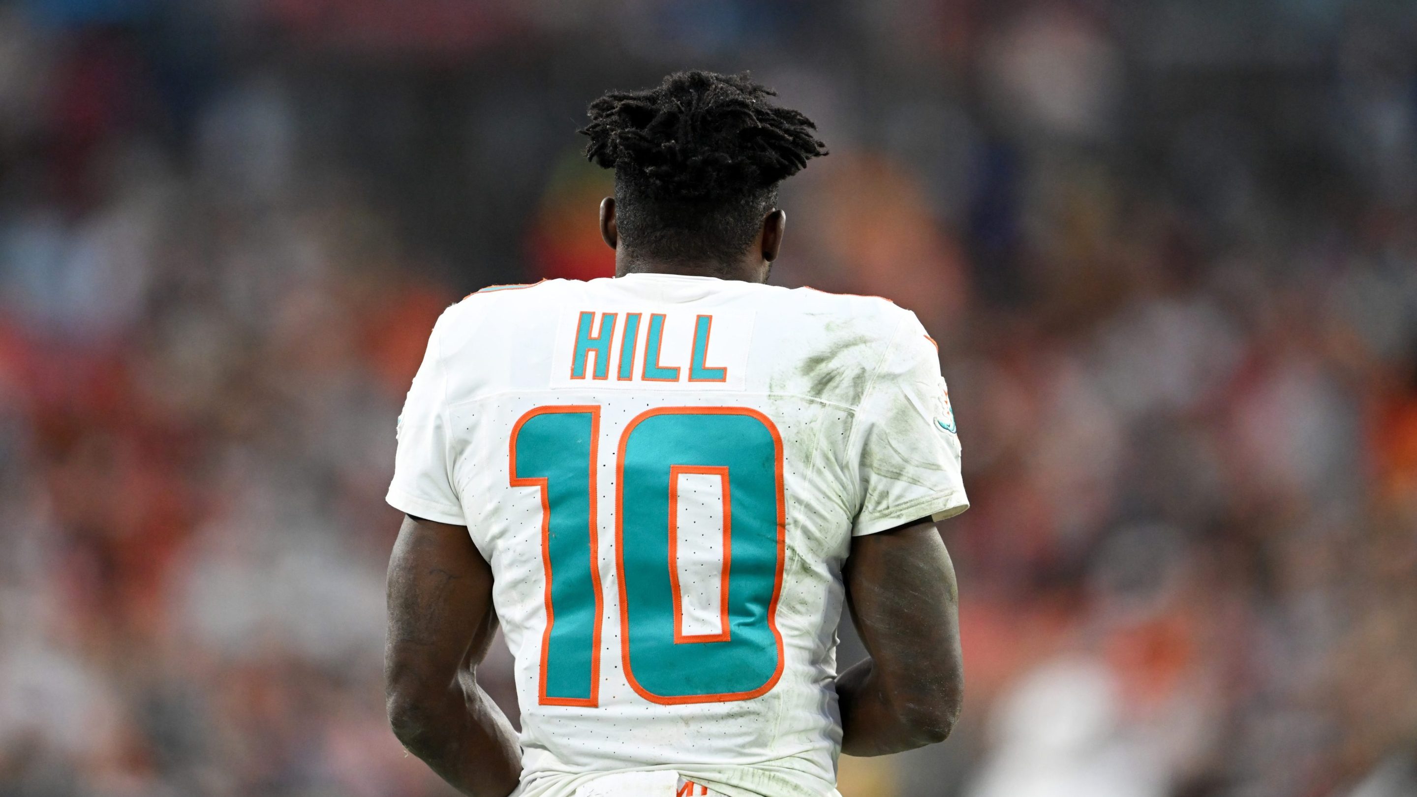 Tyreek Hill #10 of the Miami Dolphins looks on during the second quarter against the Cleveland Browns at Huntington Bank Field on December 29, 2024 in Cleveland, Ohio. His back is to the camera, only showing his jersey number and last name.