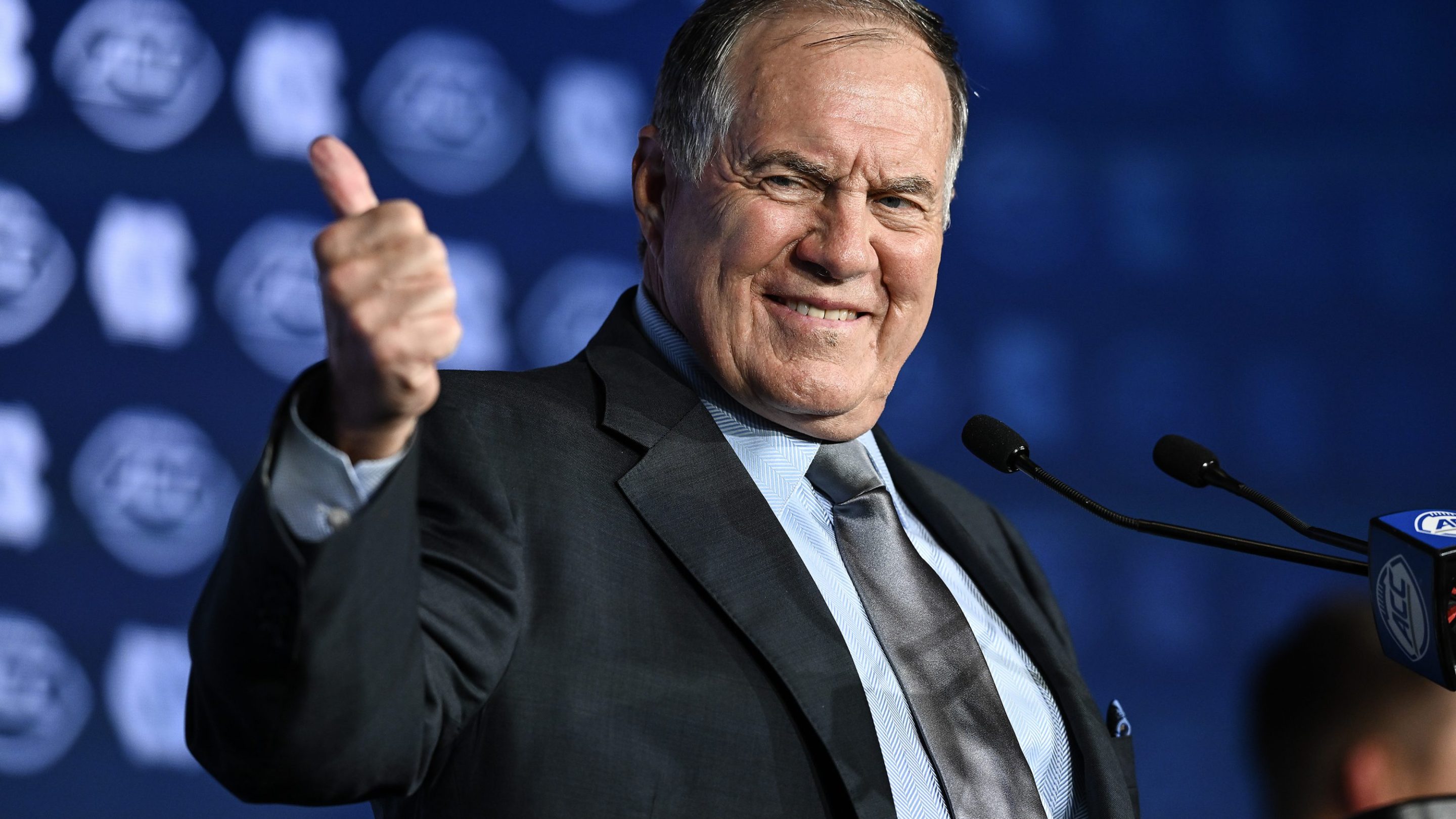 Bill Belichick giving a very awkward thumbs up to the camera.