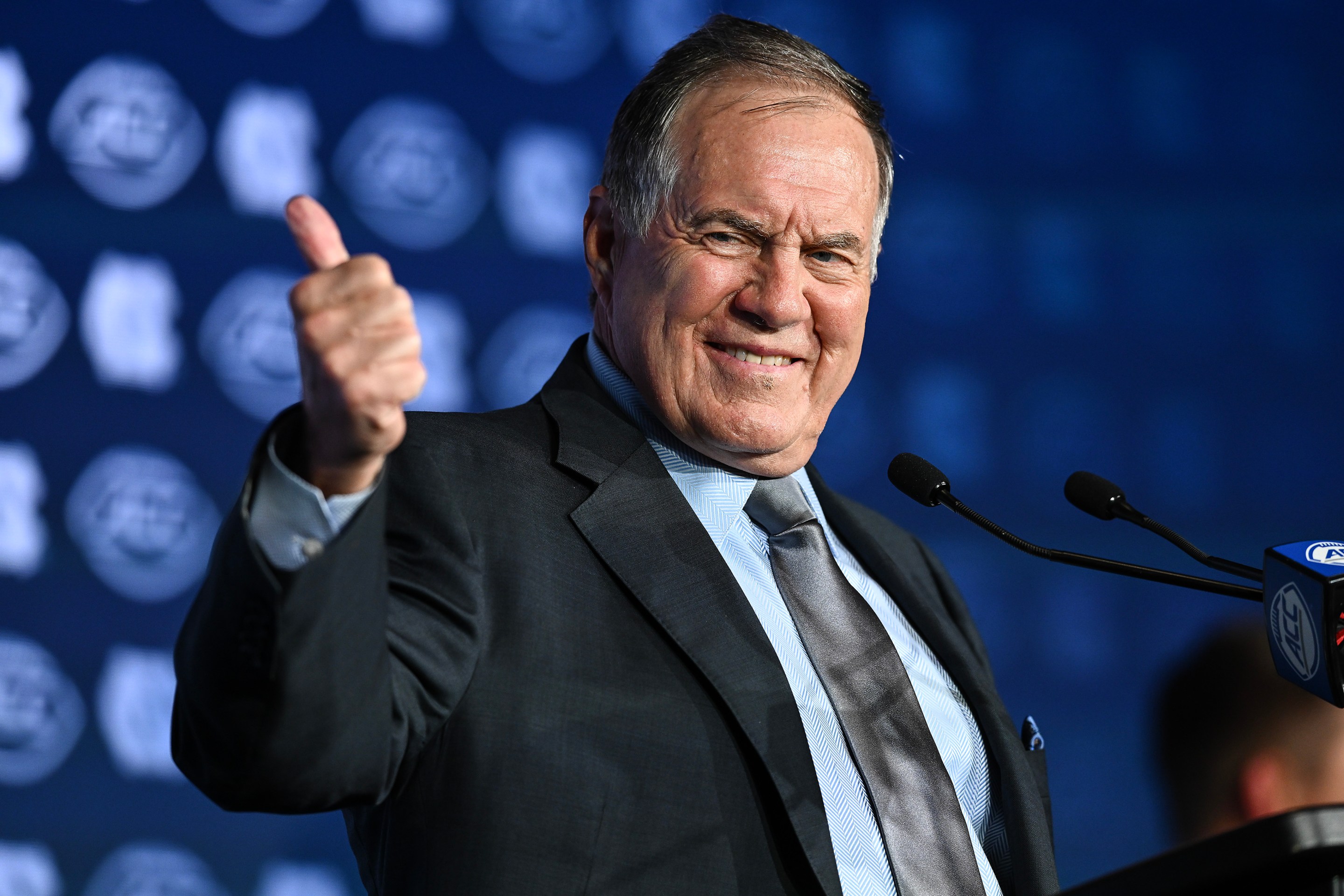 Bill Belichick giving a very awkward thumbs up to the camera.