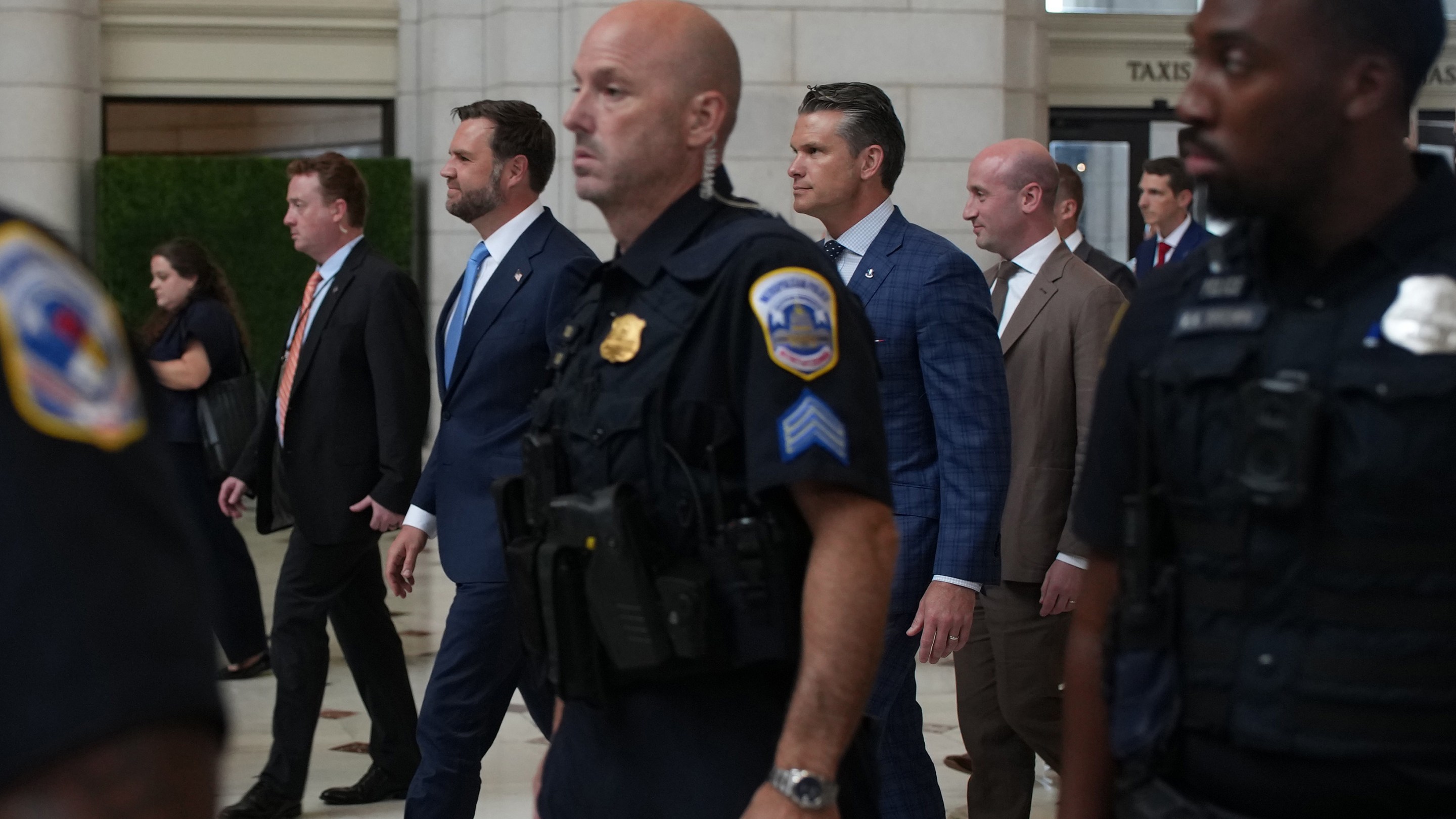 U.S. Vice President JD Vance, U.S. Defense Secretary Pete Hegseth and White House Deputy Chief of Staff Stephen Miller depart Union Station after meeting with federal law enforcement officers on August 20, 2025.