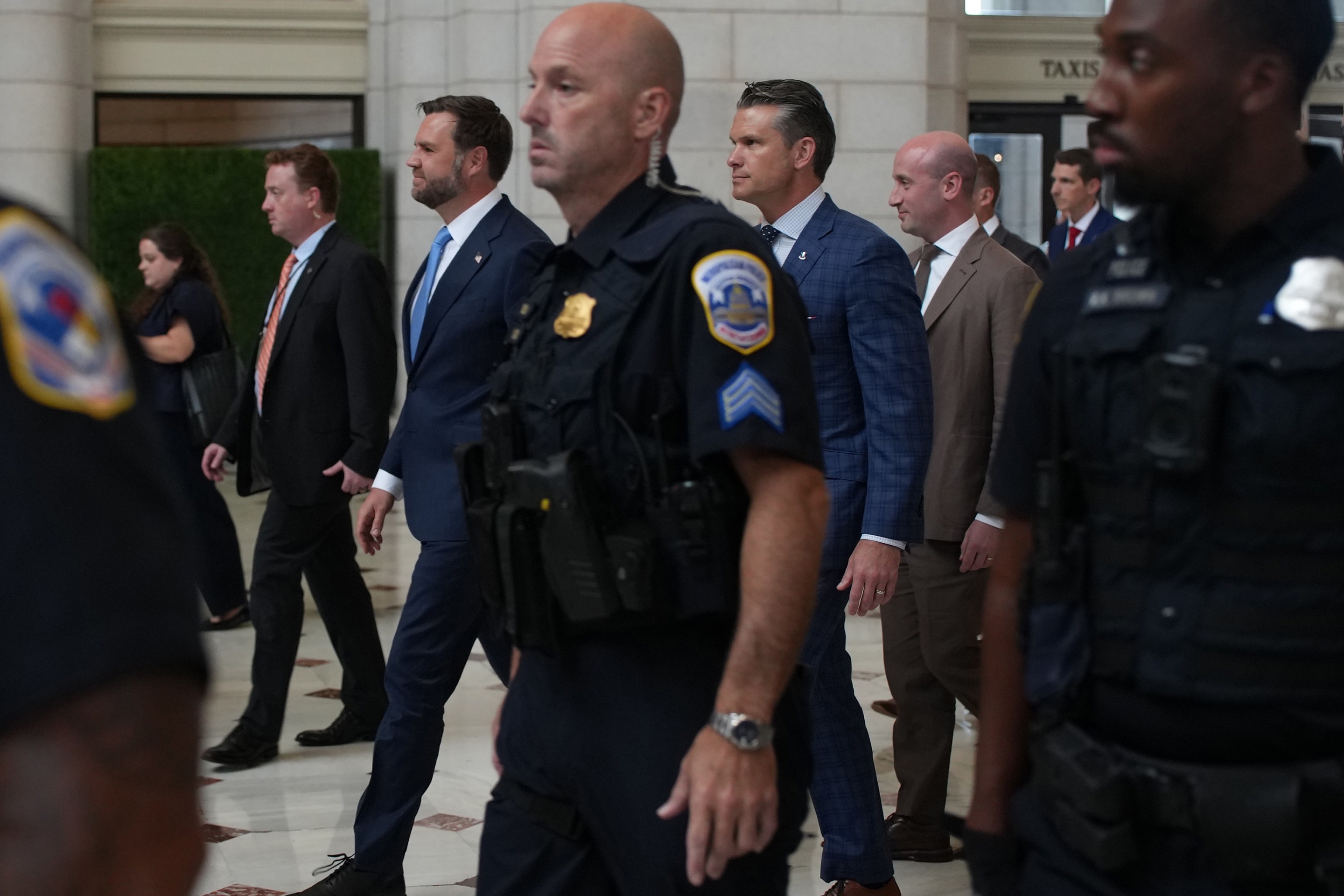 U.S. Vice President JD Vance, U.S. Defense Secretary Pete Hegseth and White House Deputy Chief of Staff Stephen Miller depart Union Station after meeting with federal law enforcement officers on August 20, 2025.