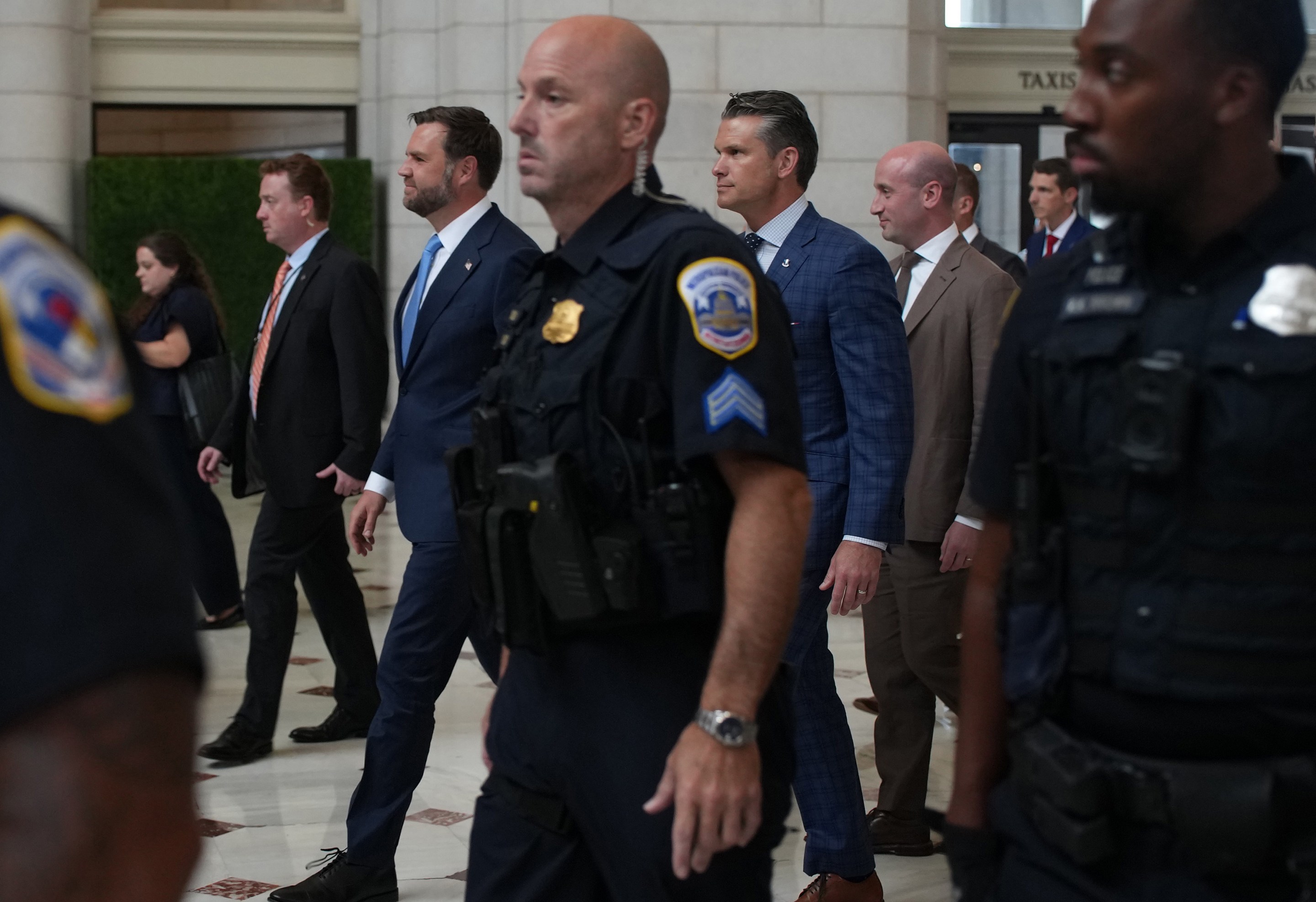 U.S. Vice President JD Vance, U.S. Defense Secretary Pete Hegseth and White House Deputy Chief of Staff Stephen Miller depart Union Station after meeting with federal law enforcement officers on August 20, 2025.