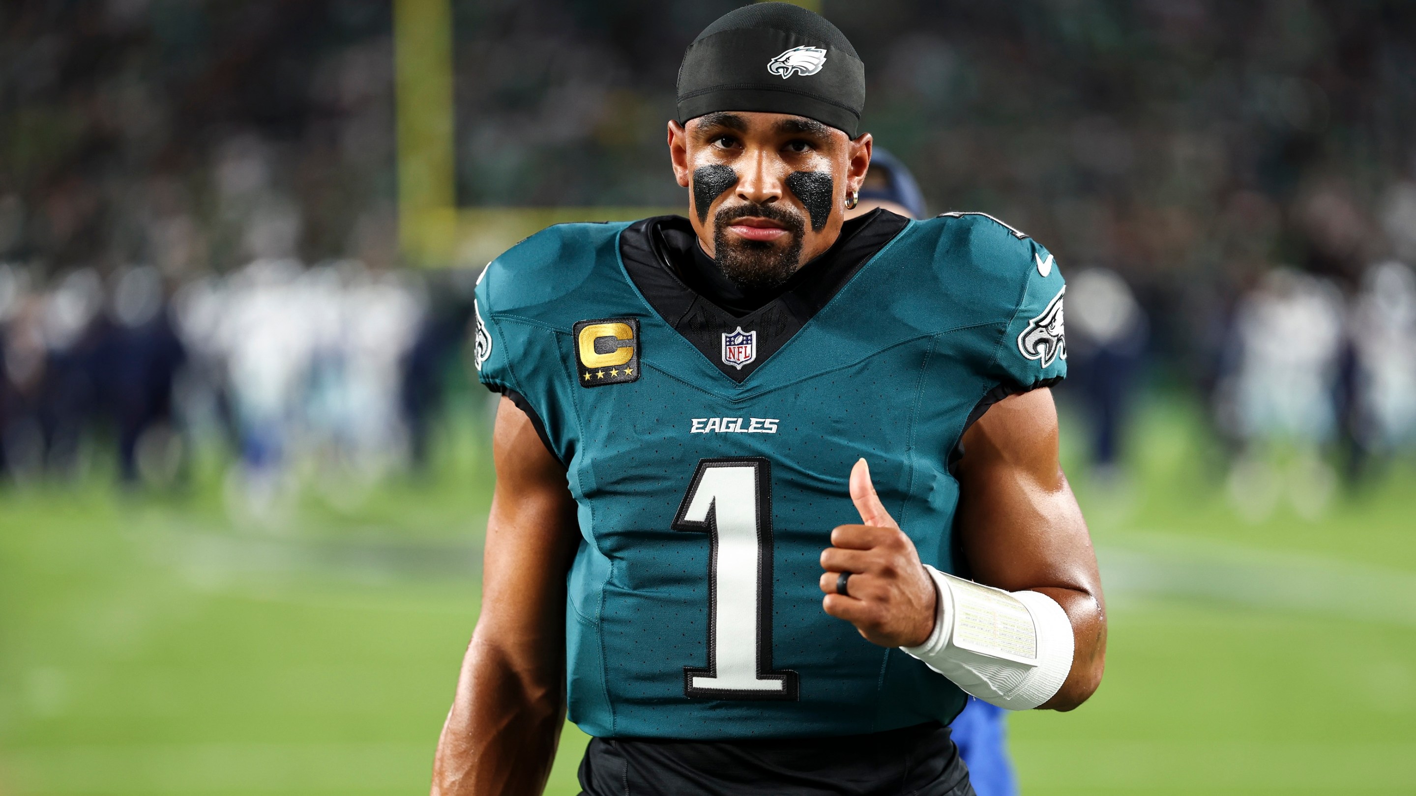 Jalen Hurts of the Philadelphia Eagles walks to the team huddle with his thumb up prior to an NFL football game against the Dallas Cowboys at Lincoln Financial Field on September 4, 2025.