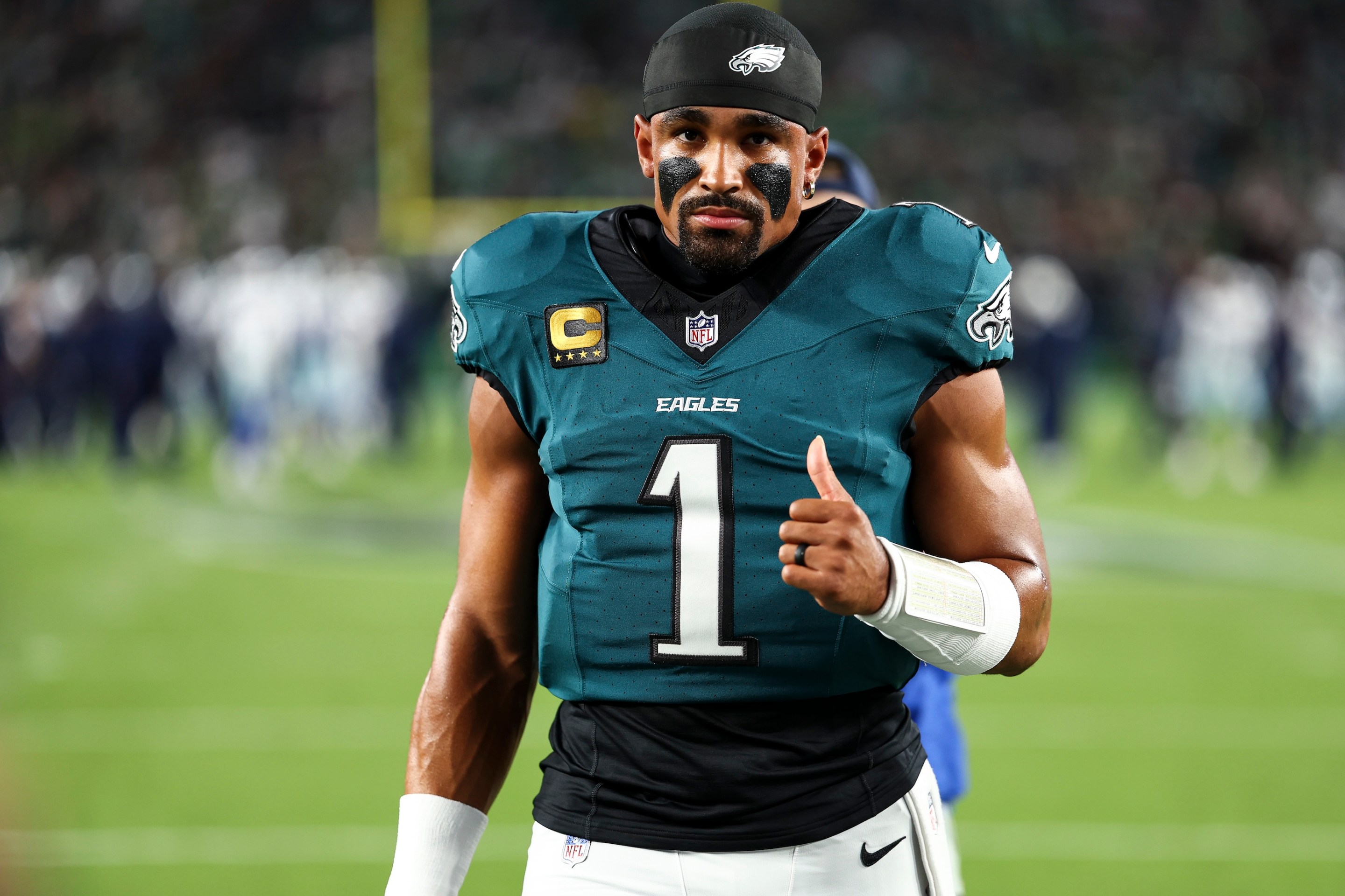 Jalen Hurts of the Philadelphia Eagles walks to the team huddle with his thumb up prior to an NFL football game against the Dallas Cowboys at Lincoln Financial Field on September 4, 2025.