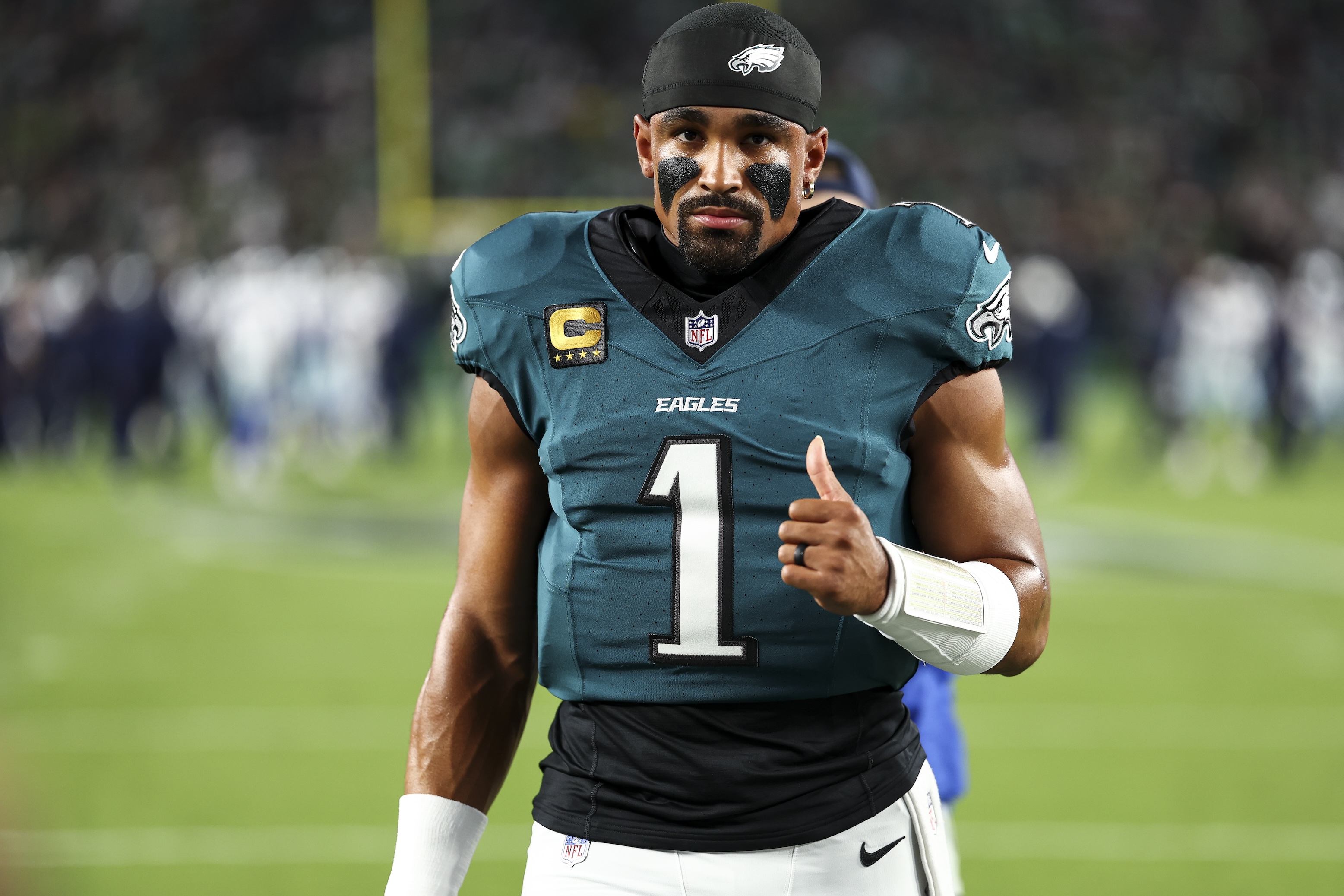 Jalen Hurts of the Philadelphia Eagles walks to the team huddle with his thumb up prior to an NFL football game against the Dallas Cowboys at Lincoln Financial Field on September 4, 2025.