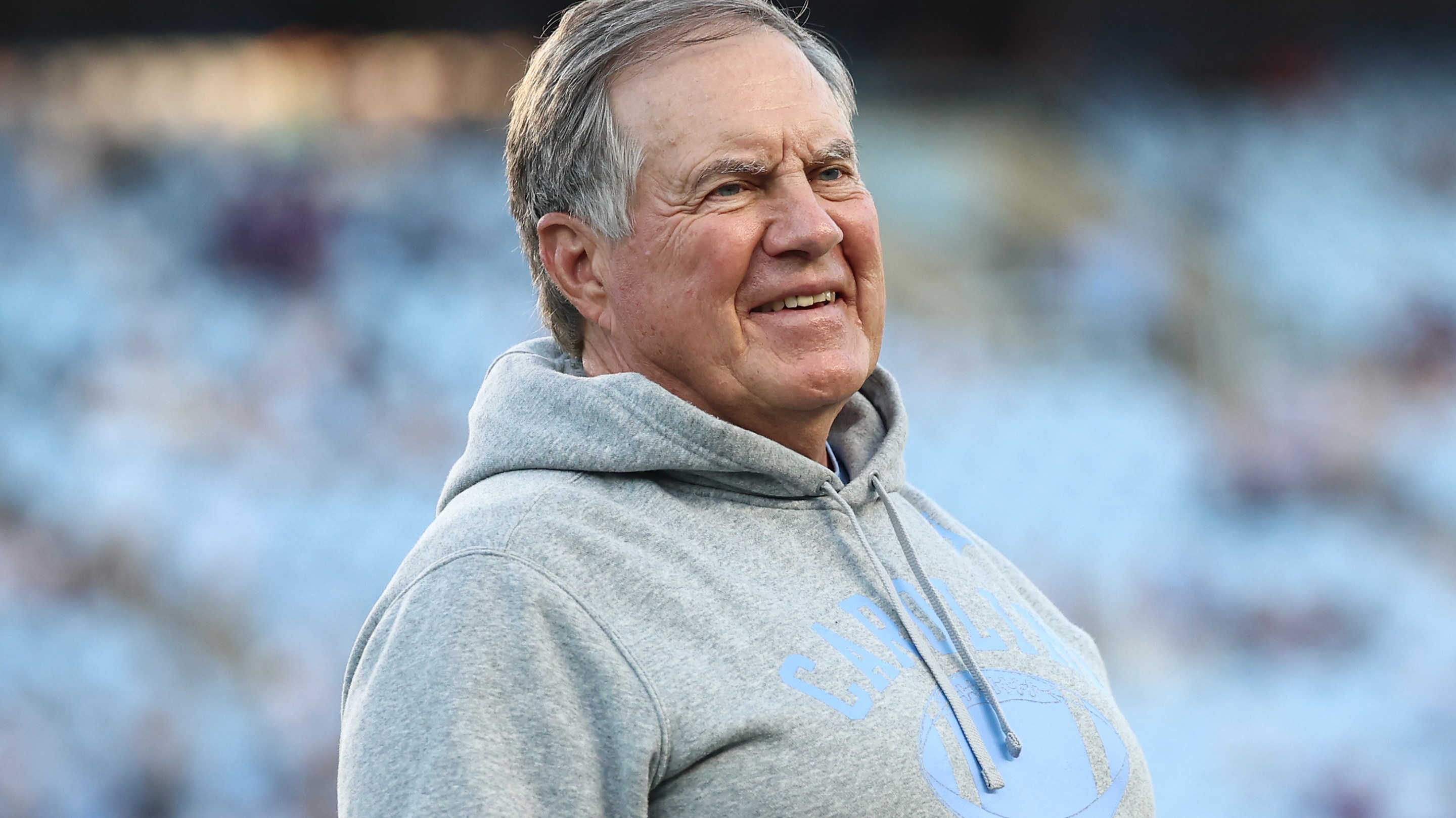 Head coach Bill Belichick of the North Carolina Tar Heels looks on prior to the game against the TCU Horned Frogs. He's sort of grimacing but maybe also smiling by his standards? Hard to say. Looks bad.