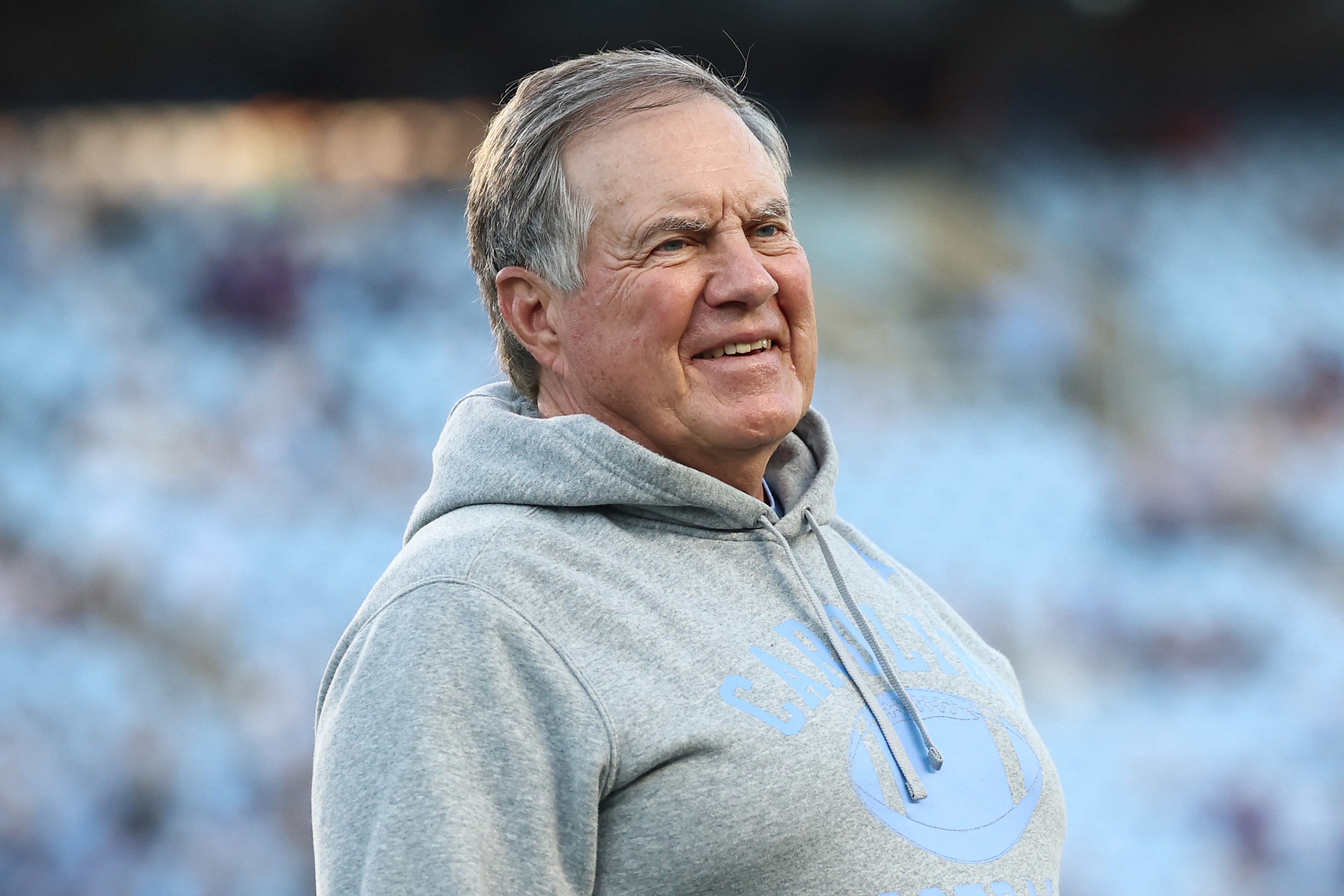 Head coach Bill Belichick of the North Carolina Tar Heels looks on prior to the game against the TCU Horned Frogs. He's sort of grimacing but maybe also smiling by his standards? Hard to say. Looks bad.
