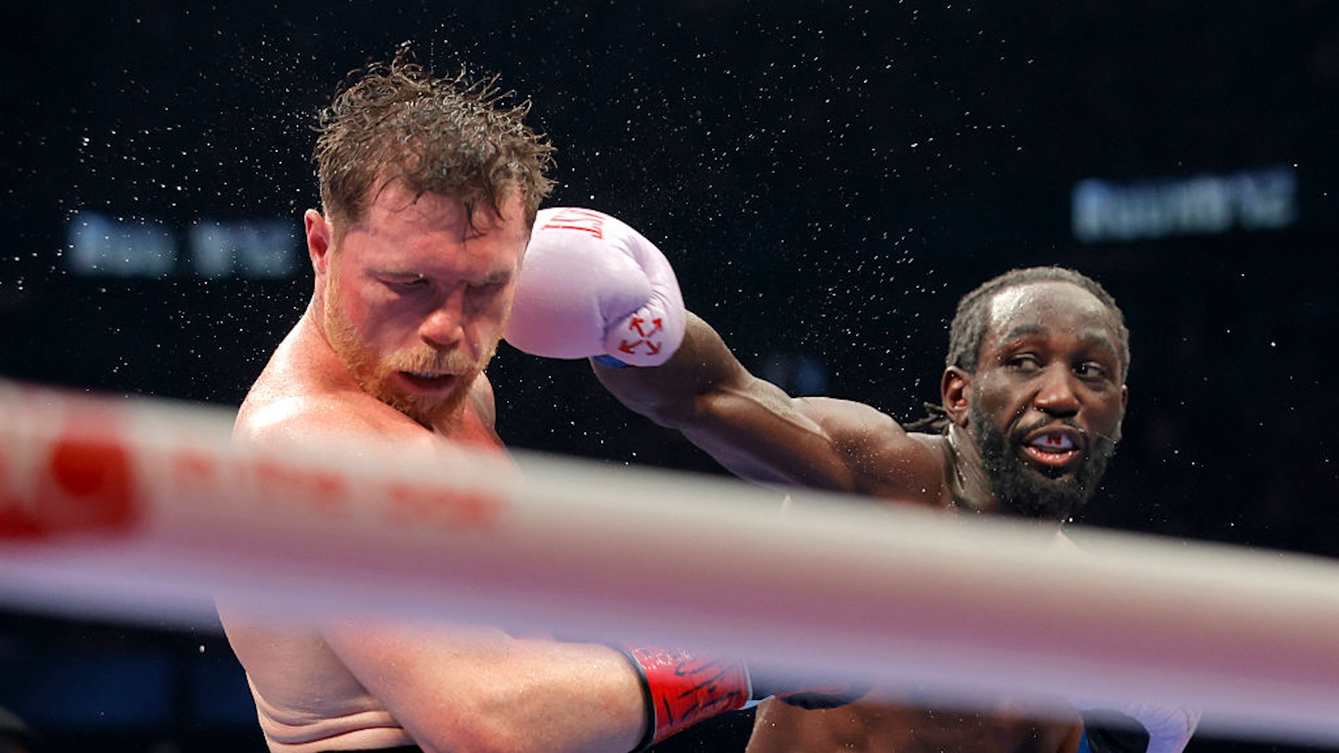 Canelo Alvarez (L) takes a punch from Terence Crawford in their undisputed super middleweight title fight during Netflix's Canelo v Crawford Fight Night at Allegiant Stadium on September 13, 2025 in Las Vegas, Nevada.