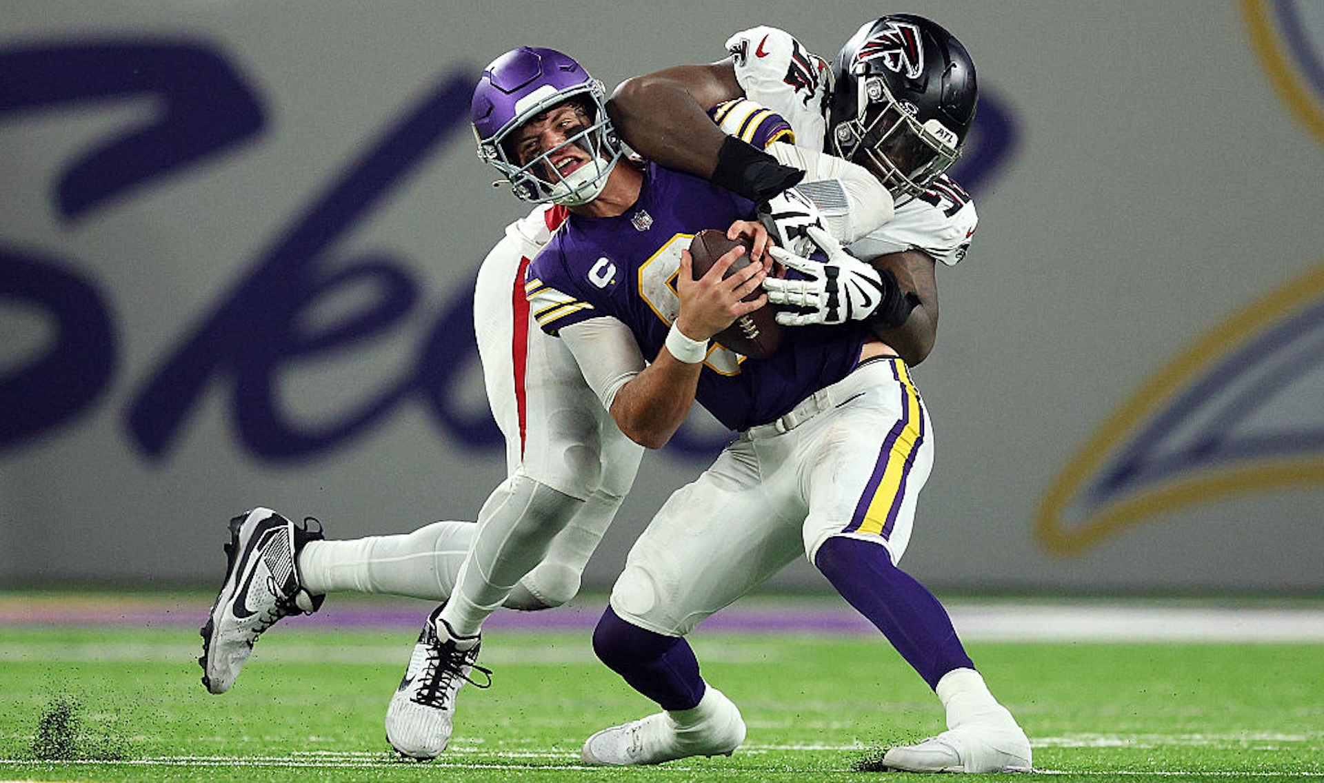 J.J. McCarthy #9 of the Minnesota Vikings fumbles the ball as he's sacked by Zach Harrison #96 of the Atlanta Falcons in the fourth quarter during the NFL 2025 game at U.S. Bank Stadium on September 14, 2025 in Minneapolis, Minnesota.