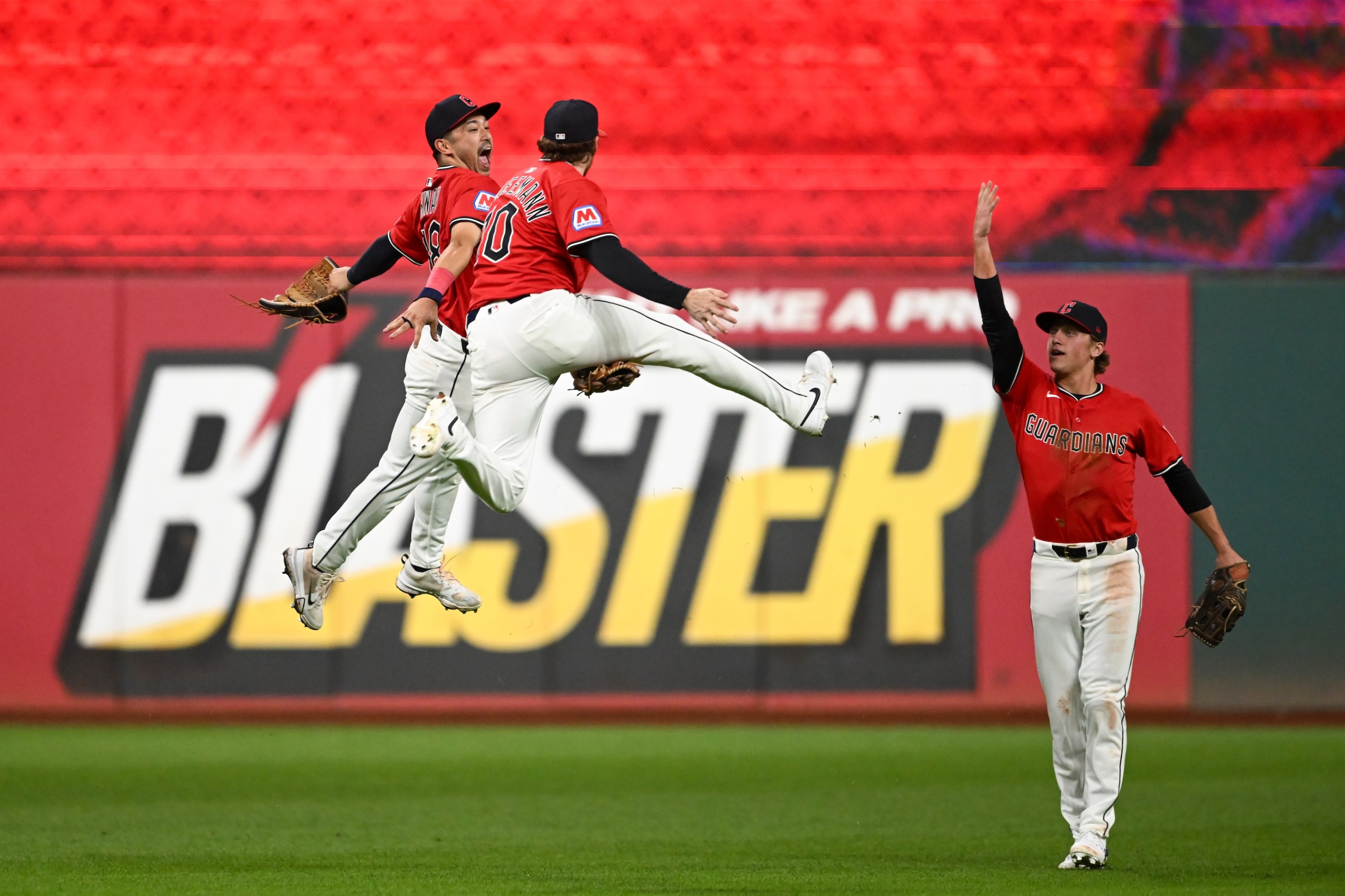 CLEVELAND, OHIO - SEPTEMBER 23: Steven Kwan #38, Daniel Schneemann #10 and Petey Halpin #0 of the Cleveland Guardians celebrate the team's 5-2 win over the Detroit Tigers at Progressive Field on September 23, 2025 in Cleveland, Ohio. (Photo by Nick Cammett/Getty Images)