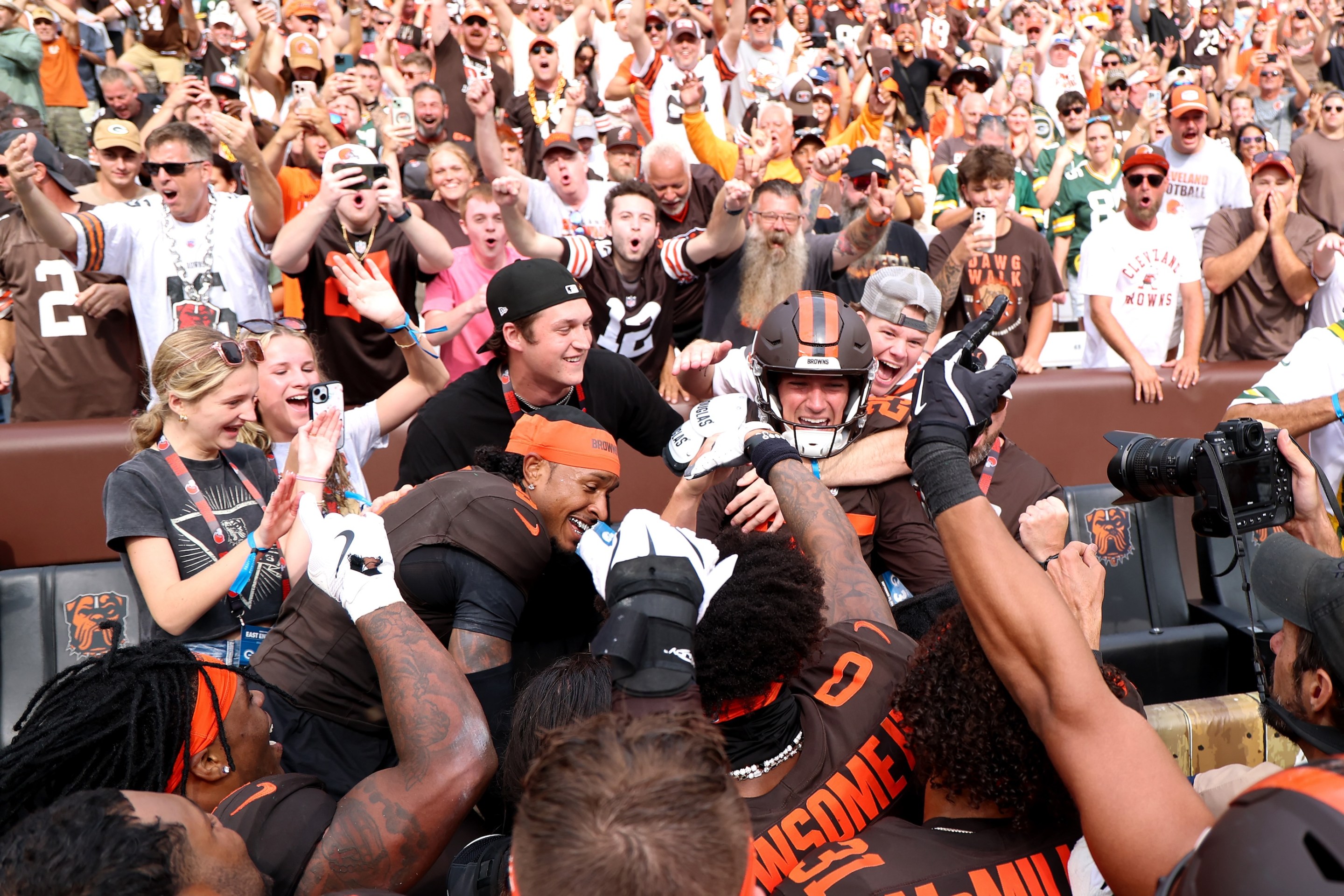 Andre Szmyt #25 of the Cleveland Browns celebrates with teammates and fans after kicking a game-winning field goal against the Green Bay Packers.