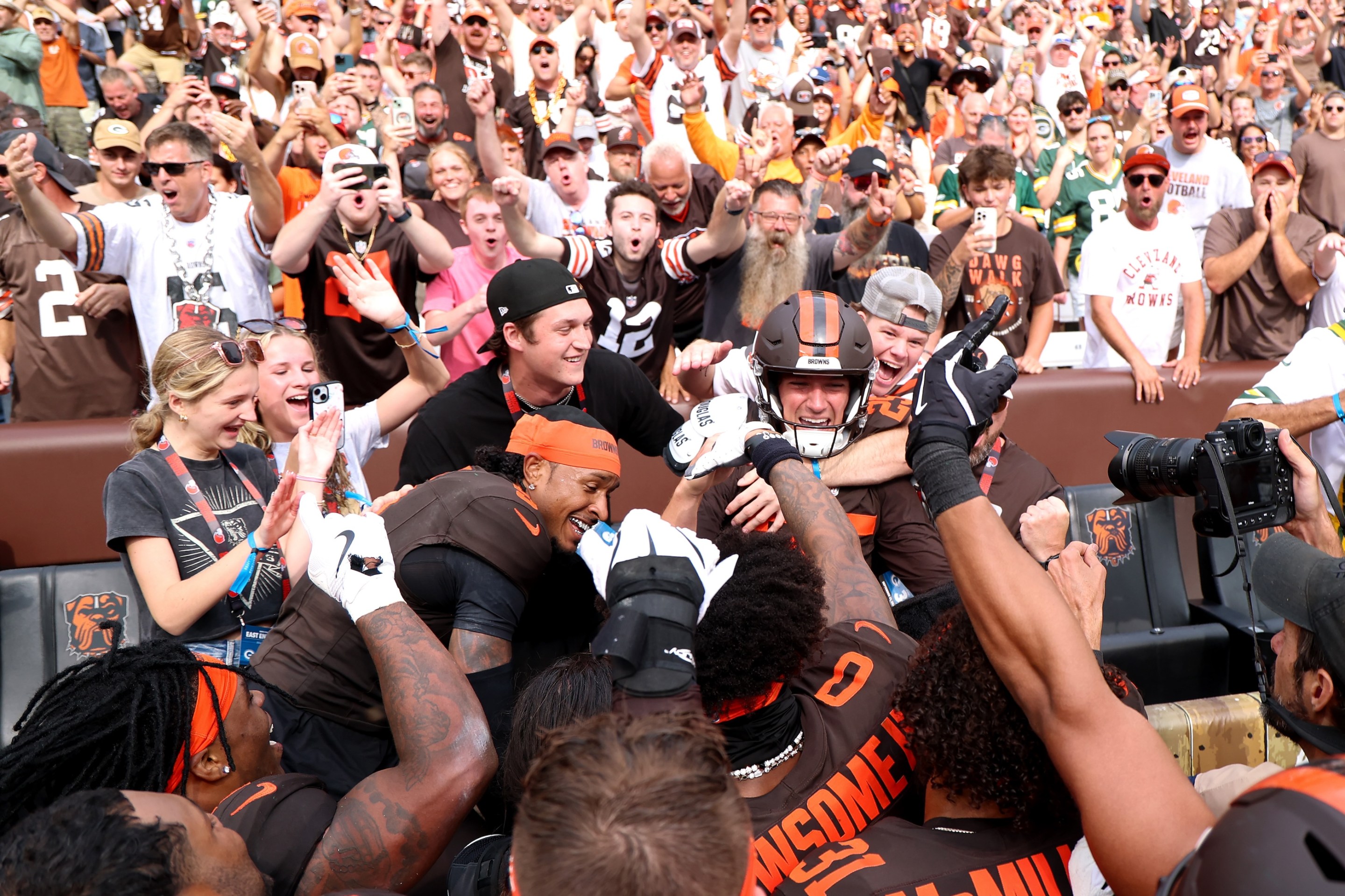 Andre Szmyt #25 of the Cleveland Browns celebrates with teammates and fans after kicking a game-winning field goal against the Green Bay Packers.