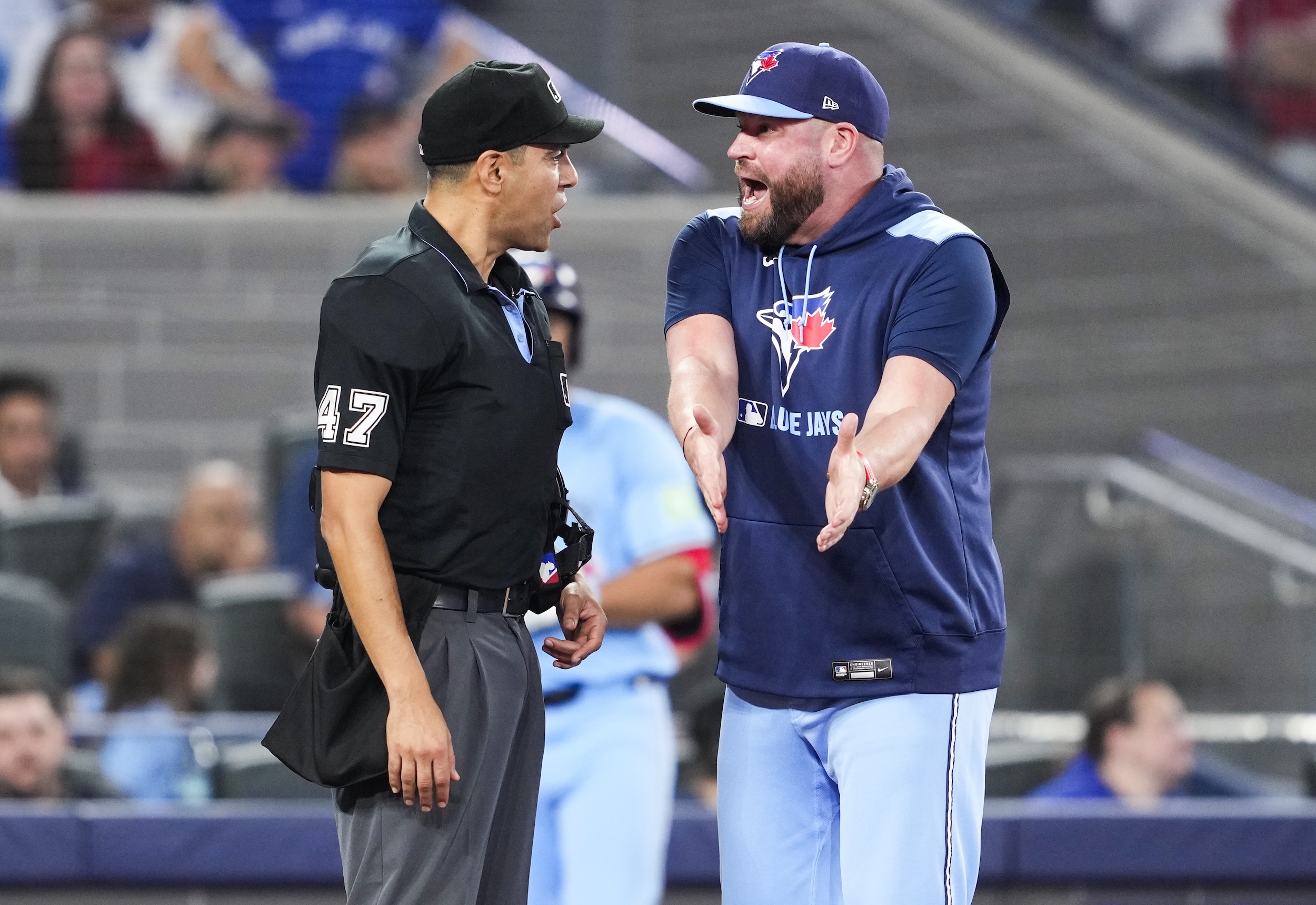 John Schneider argues with umpire Gabe Morales.