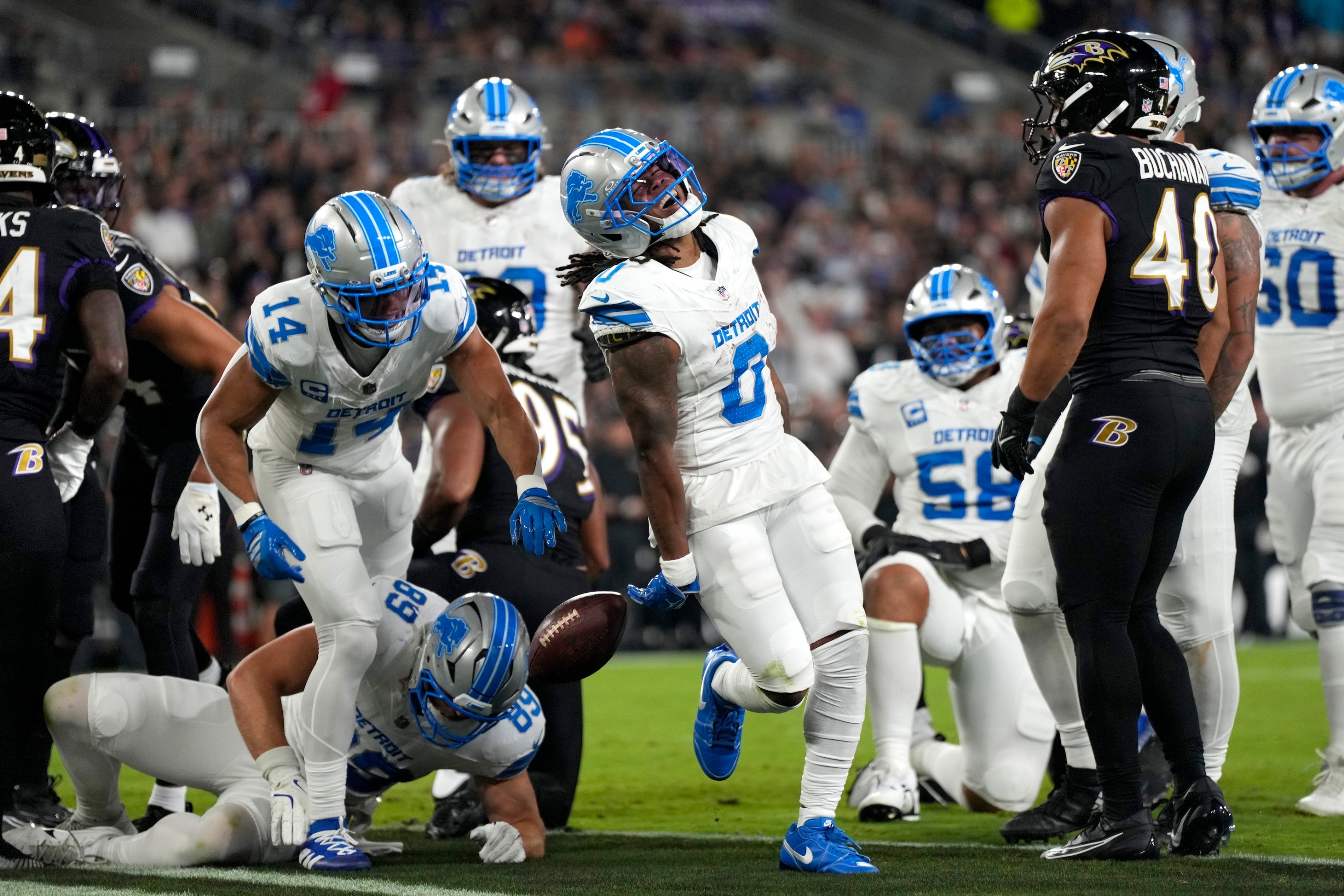Jahmyr Gibbs of the Detroit Lions celebrates scoring a touchdown against the Baltimore Ravens on Monday Night Football, September 22, 2025. He's yelling, his teammates are yelling, and the Ravens are standing around looking sad.