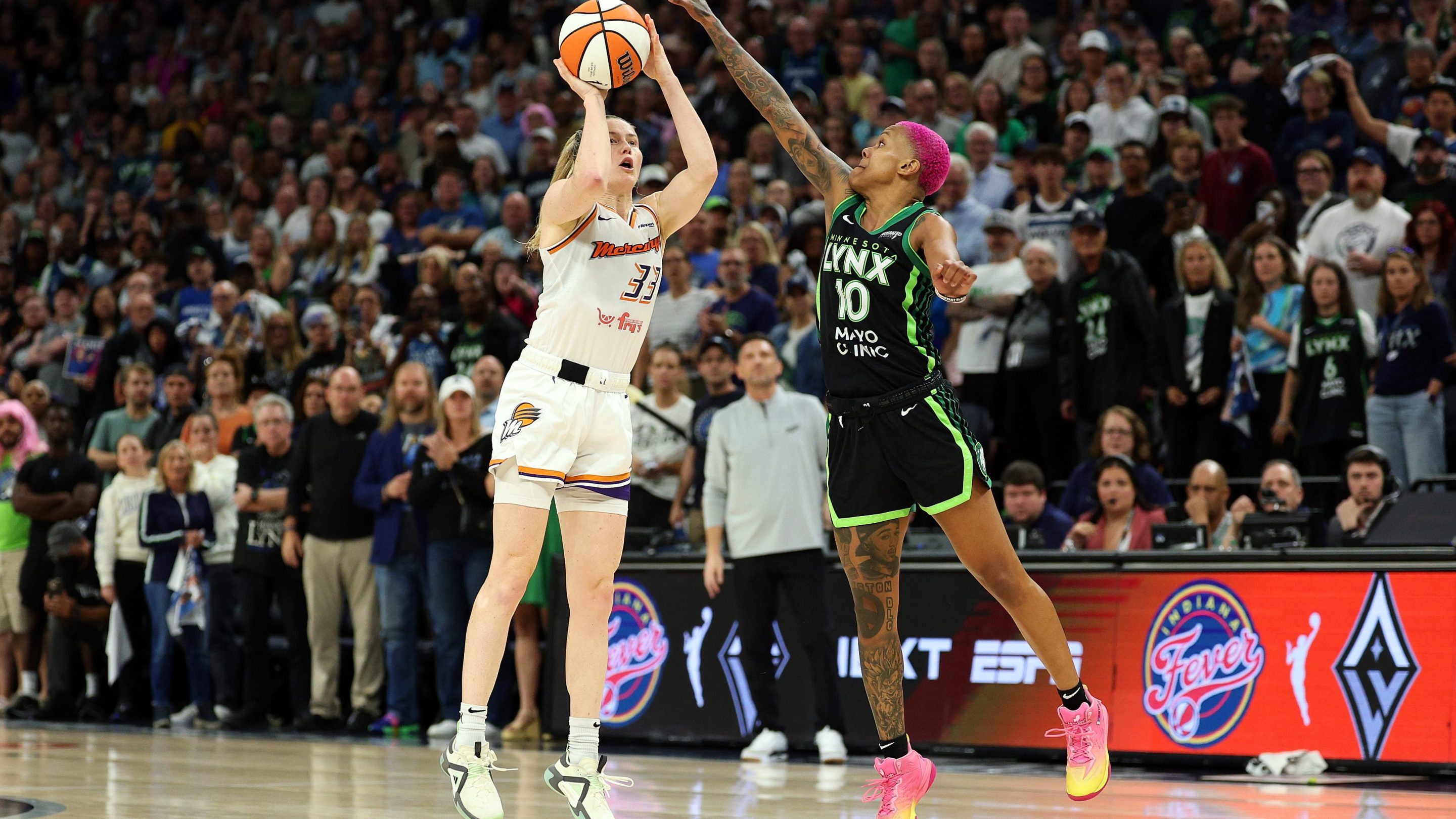 Sami Whitcomb #33 of the Phoenix Mercury shoots the ball against Courtney Williams #10 of the Minnesota Lynx in the fourth quarter during Game Two of the WNBA Semifinals at Target Center on September 23, 2025 in Minneapolis, Minnesota. The Mercury defeated the Lynx 89-83 in overtime.