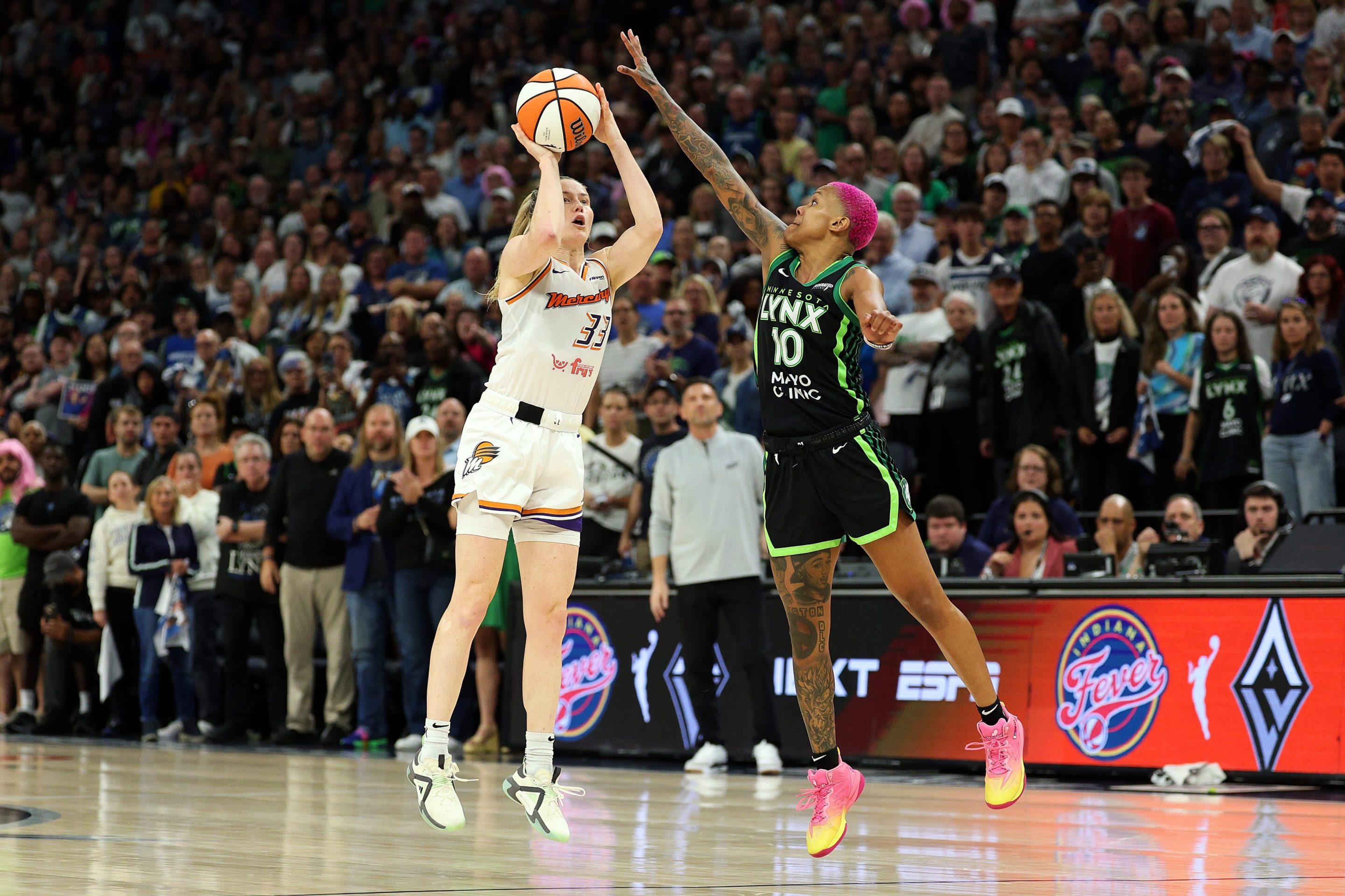 Sami Whitcomb #33 of the Phoenix Mercury shoots the ball against Courtney Williams #10 of the Minnesota Lynx in the fourth quarter during Game Two of the WNBA Semifinals at Target Center on September 23, 2025 in Minneapolis, Minnesota. The Mercury defeated the Lynx 89-83 in overtime.