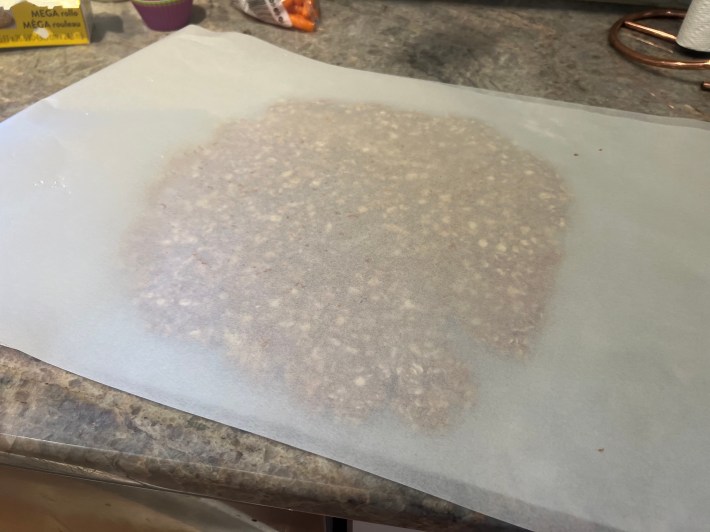 Cookie dough rolled flat between two sheets of parchment