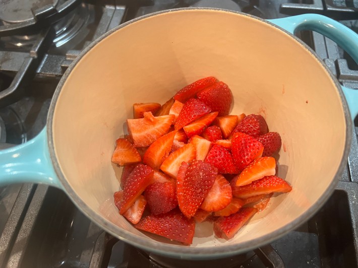 Sliced strawberries in a saucepan.