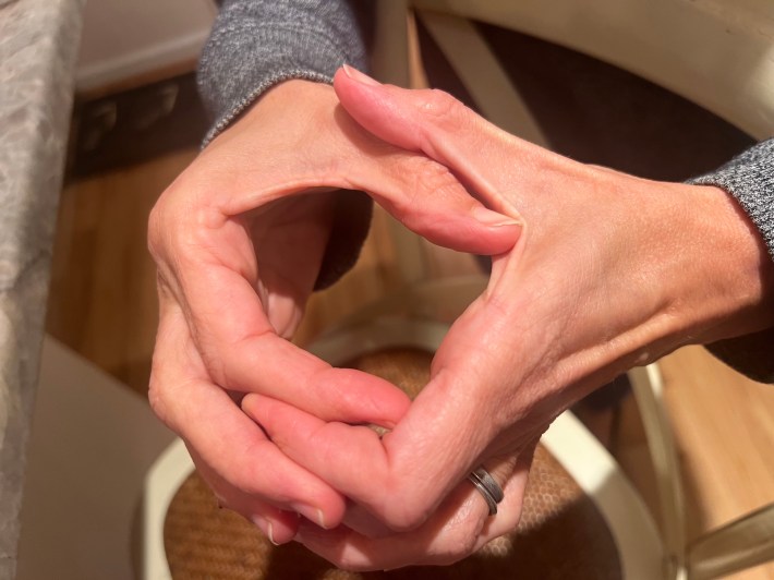 Two hands form a square shape, roughly two inches by two inches.