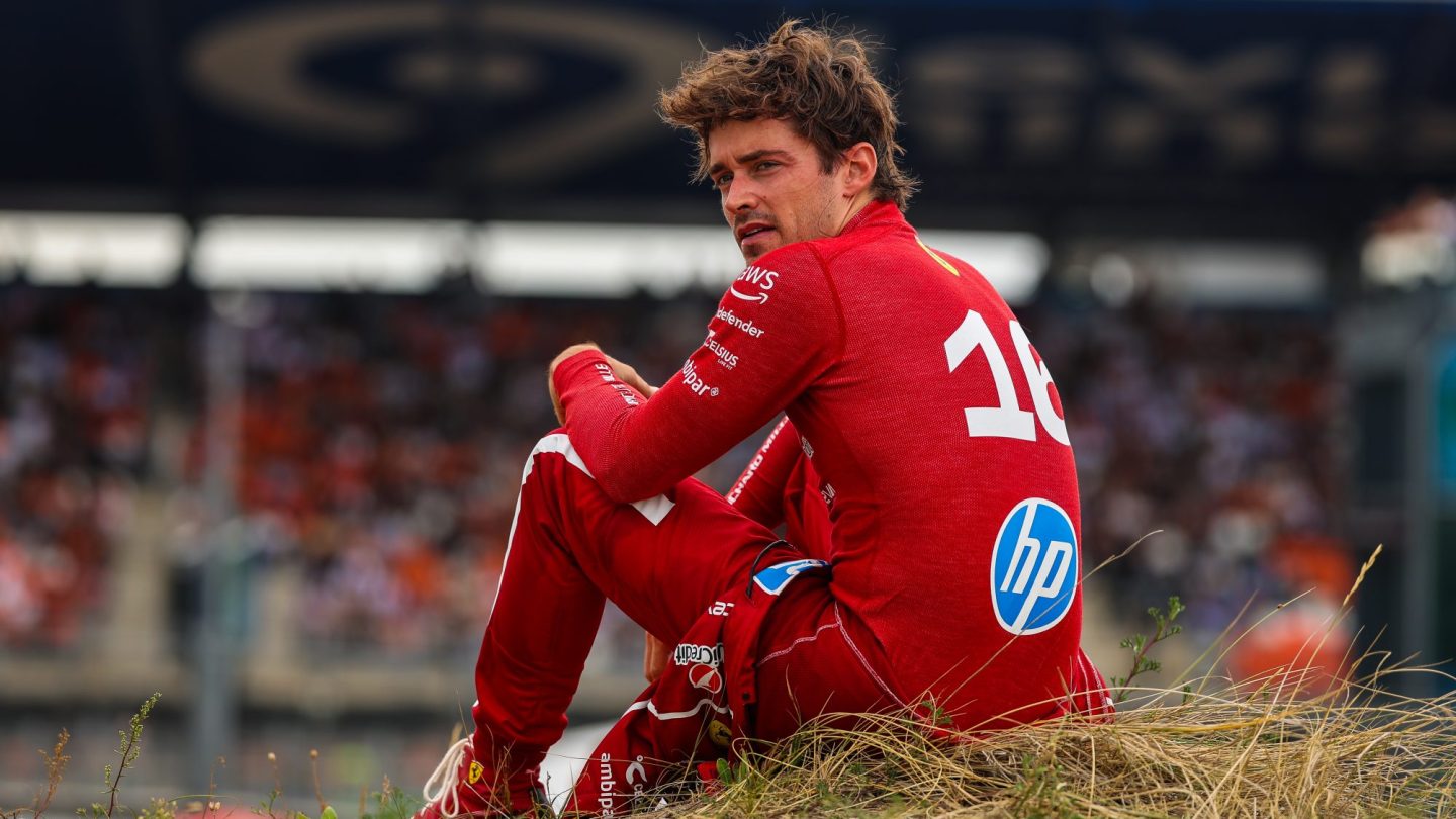Charles Leclerc of Monaco and Ferrari sits on the embankment following his crash.