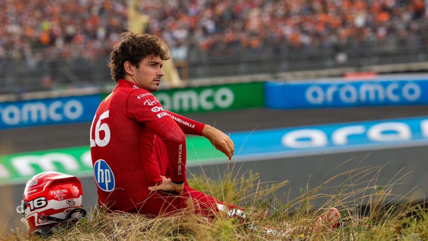 Charles Leclerc of Monaco and Ferrari looks on sitting on the embankment following his crash.