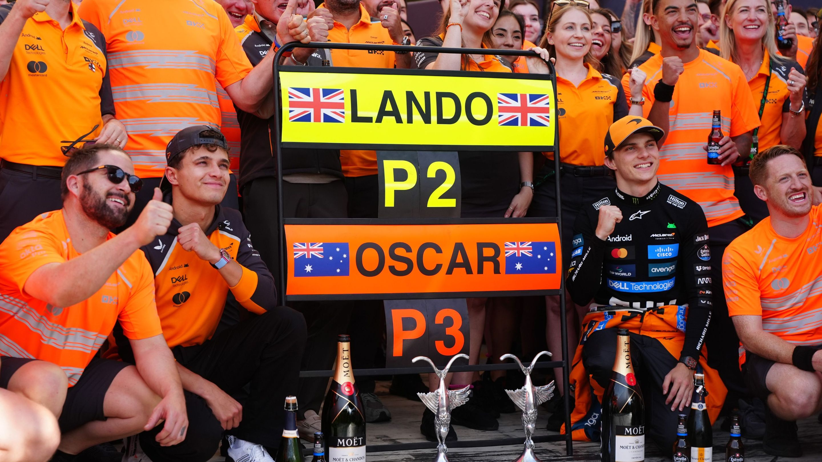 McLaren's Lando Norris (centre left) and Oscar Piastri (centre right) celebrate with the team after taking second and third respectively at the Italian Grand Prix.