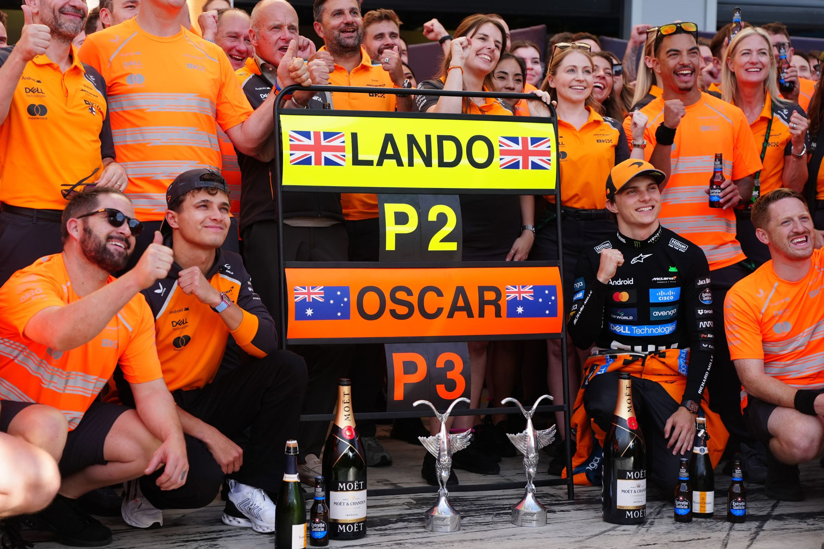 McLaren's Lando Norris (centre left) and Oscar Piastri (centre right) celebrate with the team after taking second and third respectively at the Italian Grand Prix.