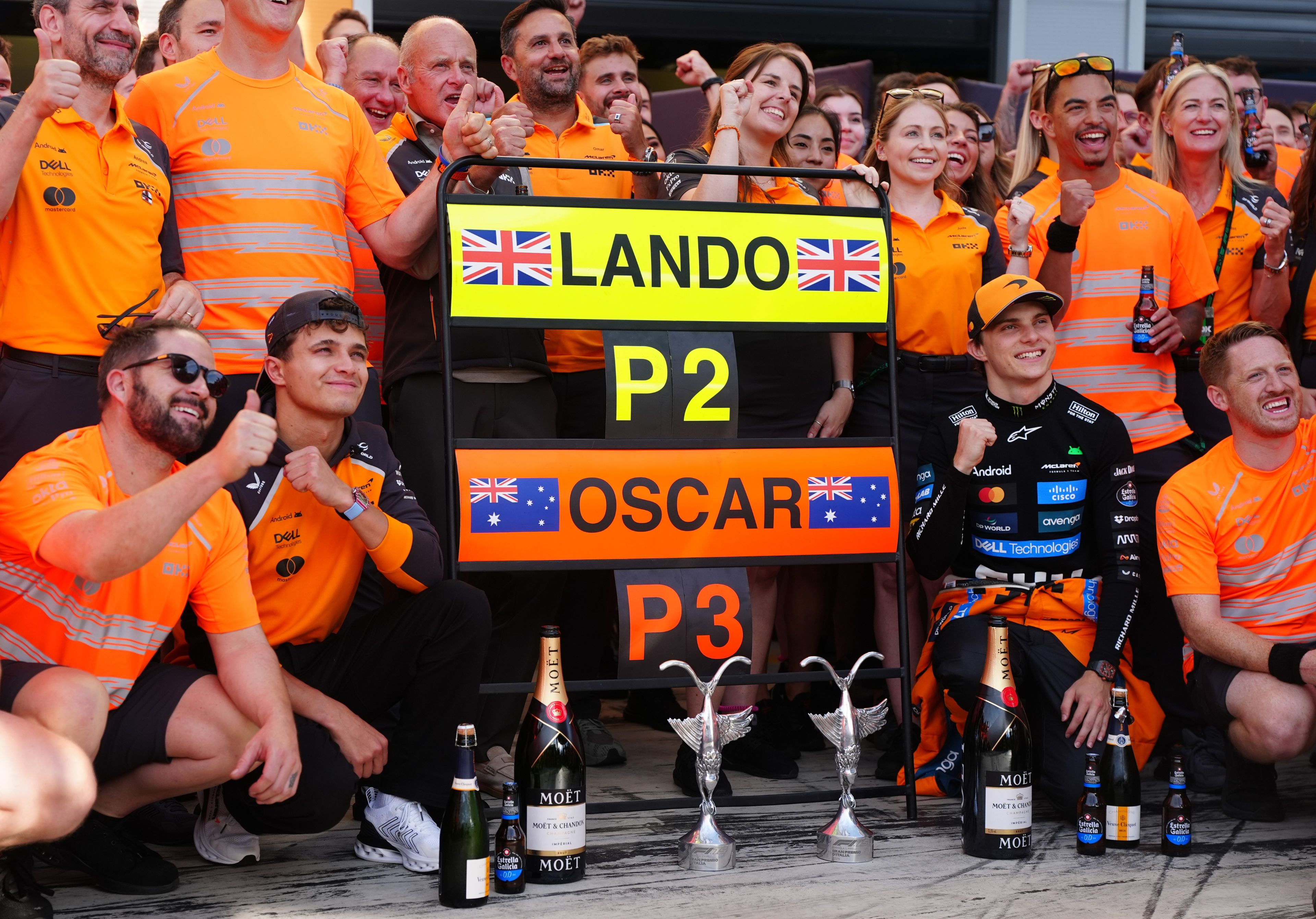 McLaren's Lando Norris (centre left) and Oscar Piastri (centre right) celebrate with the team after taking second and third respectively at the Italian Grand Prix.
