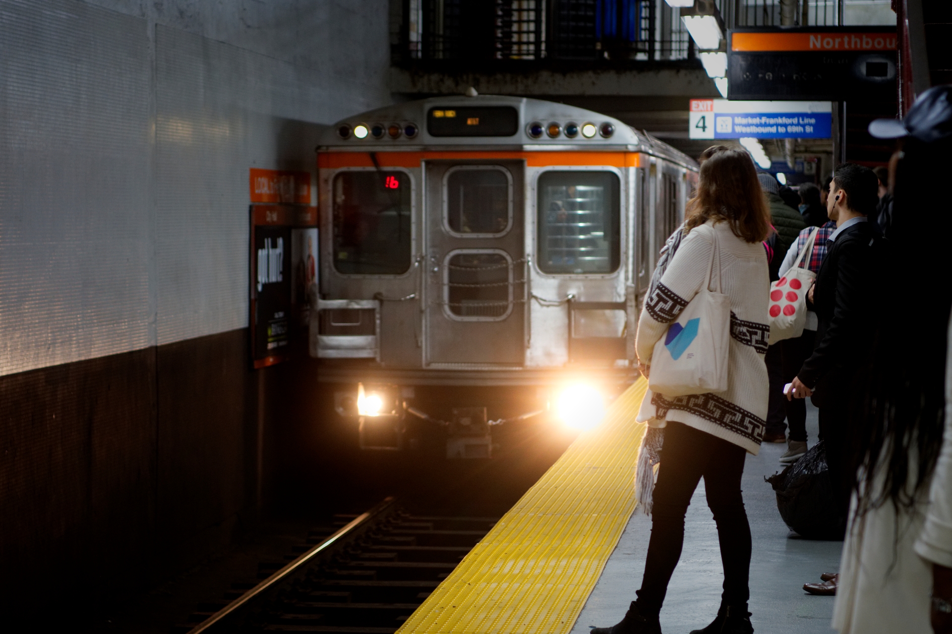 Commuters wait on the platform as a Northbound Broad Street Line train arrives at SEPTA City Hall subway station.