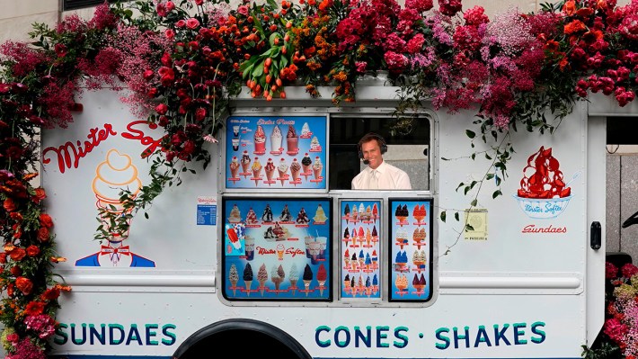 Tom Brady in his goofy white-on-white formalwear, photoshopped into the customer window of a Mister Softee truck.