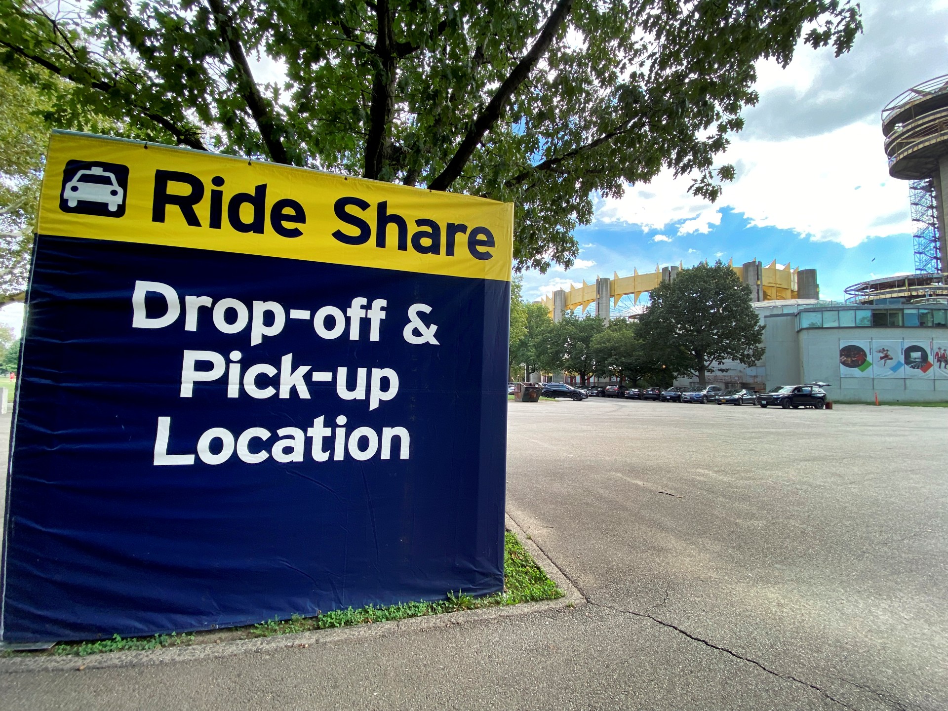 US Open, Ride Share pick up and drop off location with NY Pavilion and Queens theater in background, Flushing Meadows Corona Park, Queens, New York.