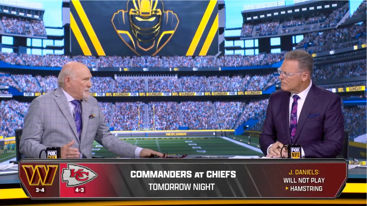 Terry Bradshaw (left) and Howie Long (right) on the set of the Fox NFL Sunday broadcast. Cleatus the Robot is in the background. Bradshaw is telling a story about texting someone he thought was Andy Reid and getting offered a chance to buy some pigs.